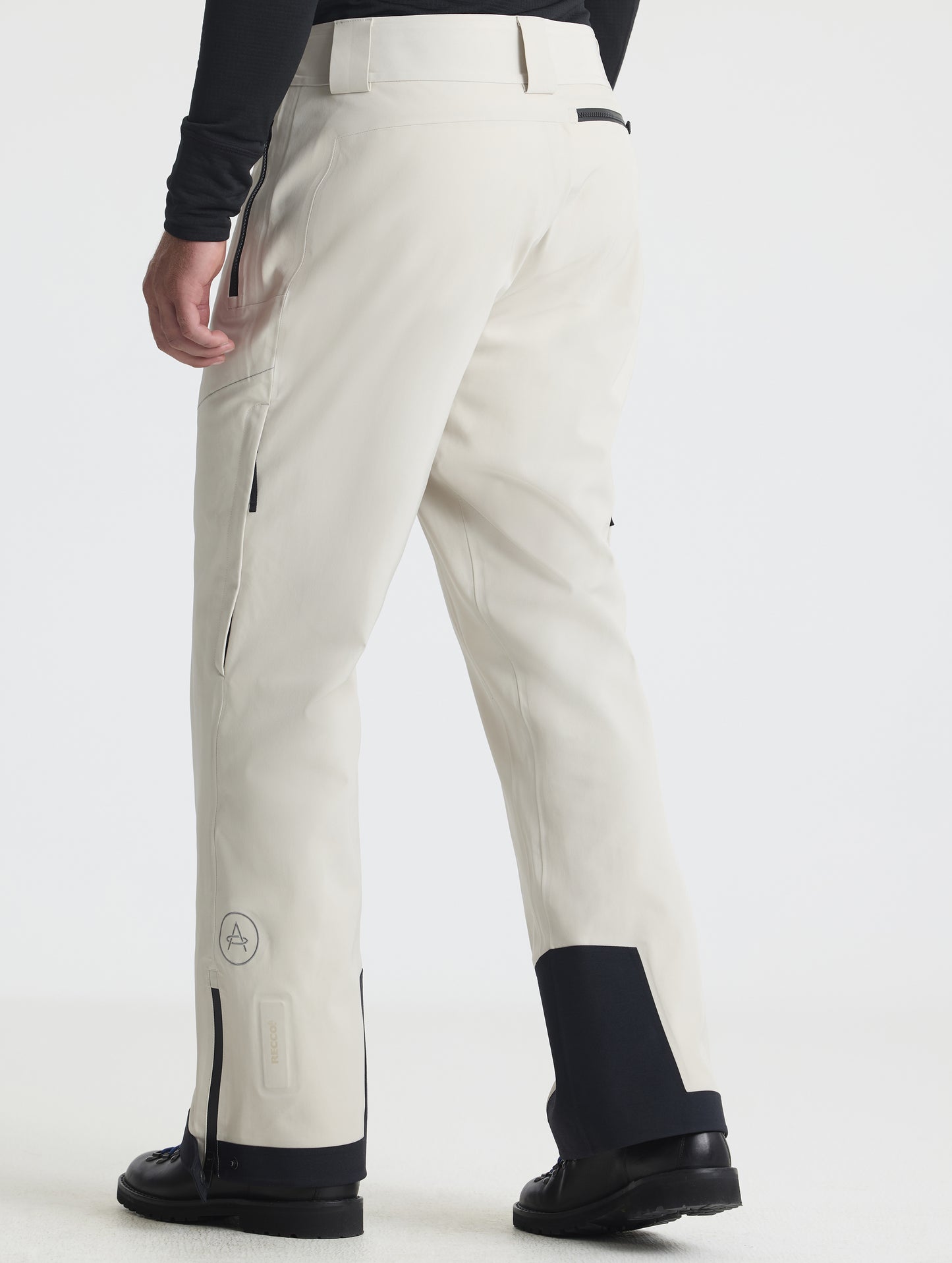 Rear angled lower-body view of man wearing the Ridge Insulated Snow Pant in Bone from AETHER Apparel.