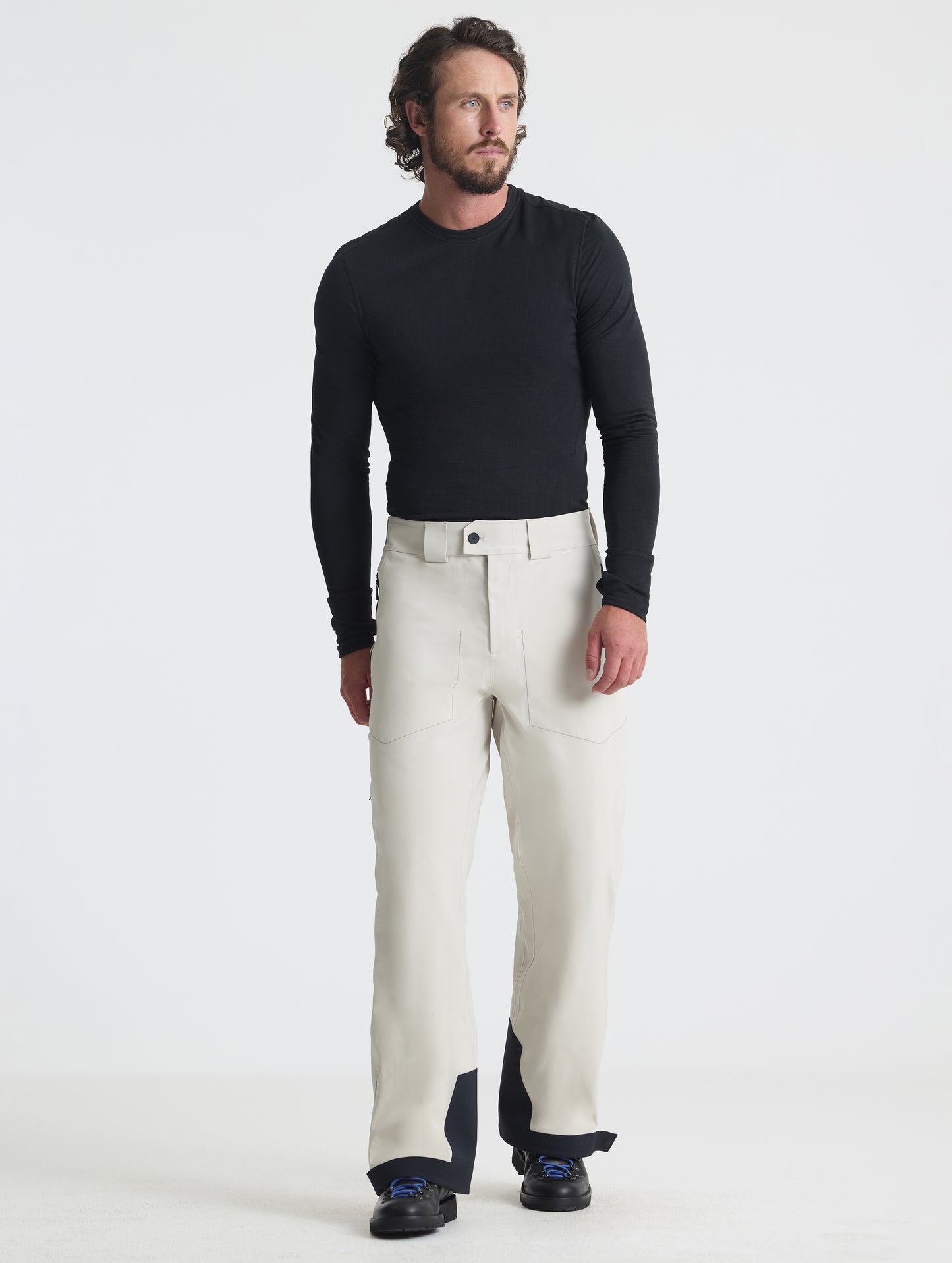 Front full-body view of man wearing the Ridge Insulated Snow Pant in Bone from AETHER Apparel.