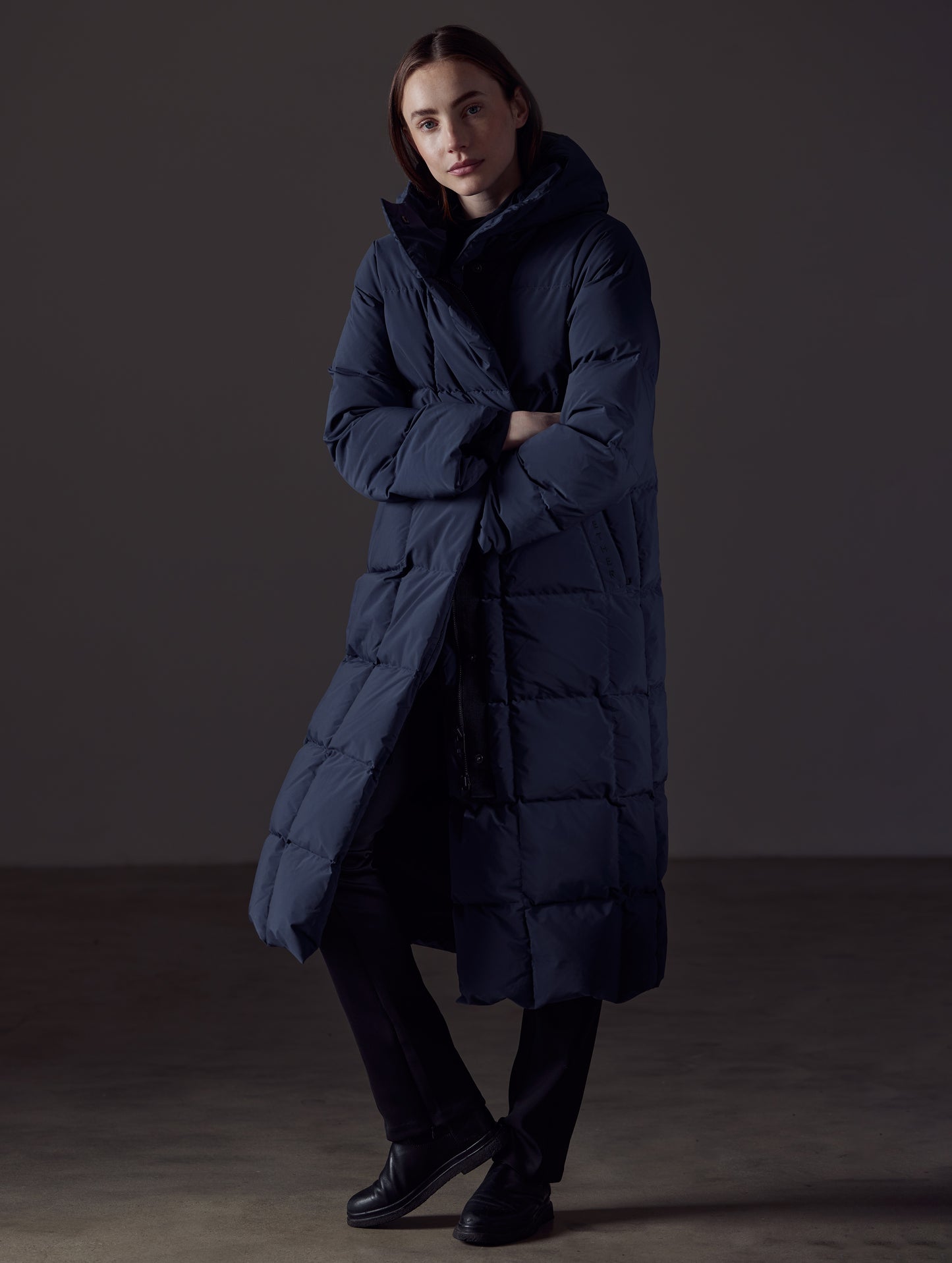 Front angled full-body view of woman wearing Shaw Jacket in Nordic Navy Blue from AETHER Apparel.