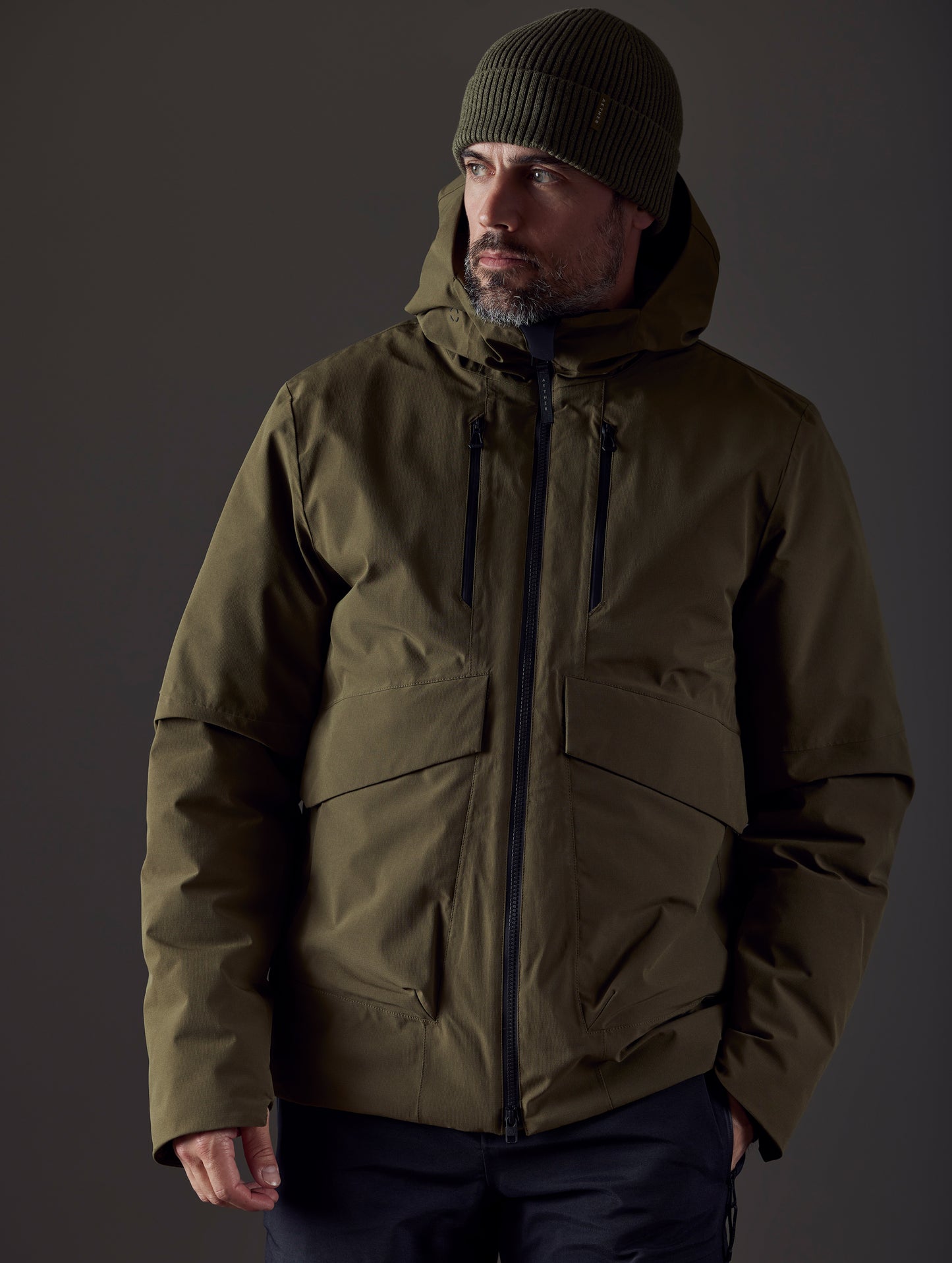 Front body view of man wearing Silverton Down Jacket in Command Green from AETHER Apparel.