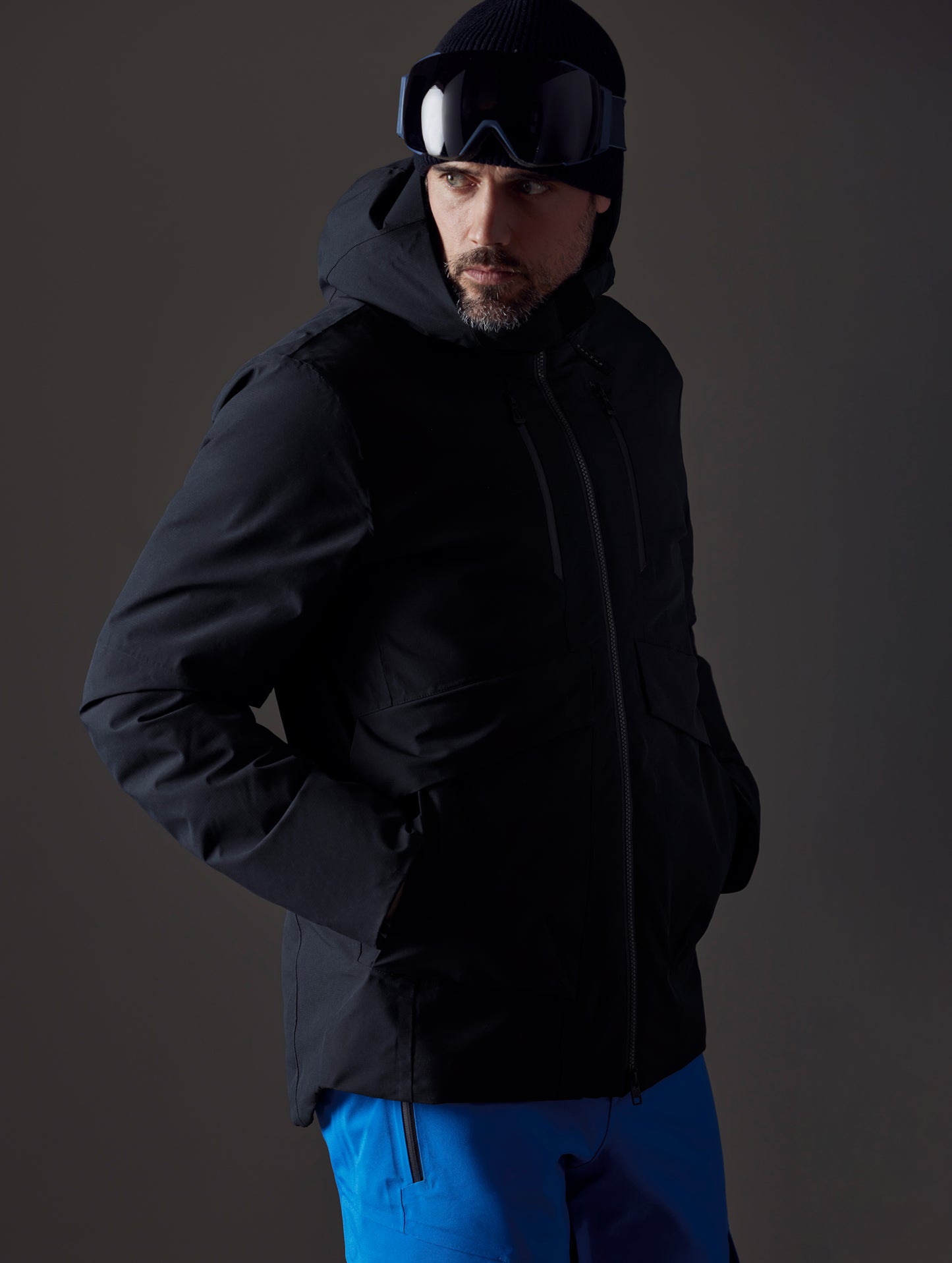 Front 3/4 body view of man wearing Silverton Down Jacket in Onyx Black from AETHER Apparel.
