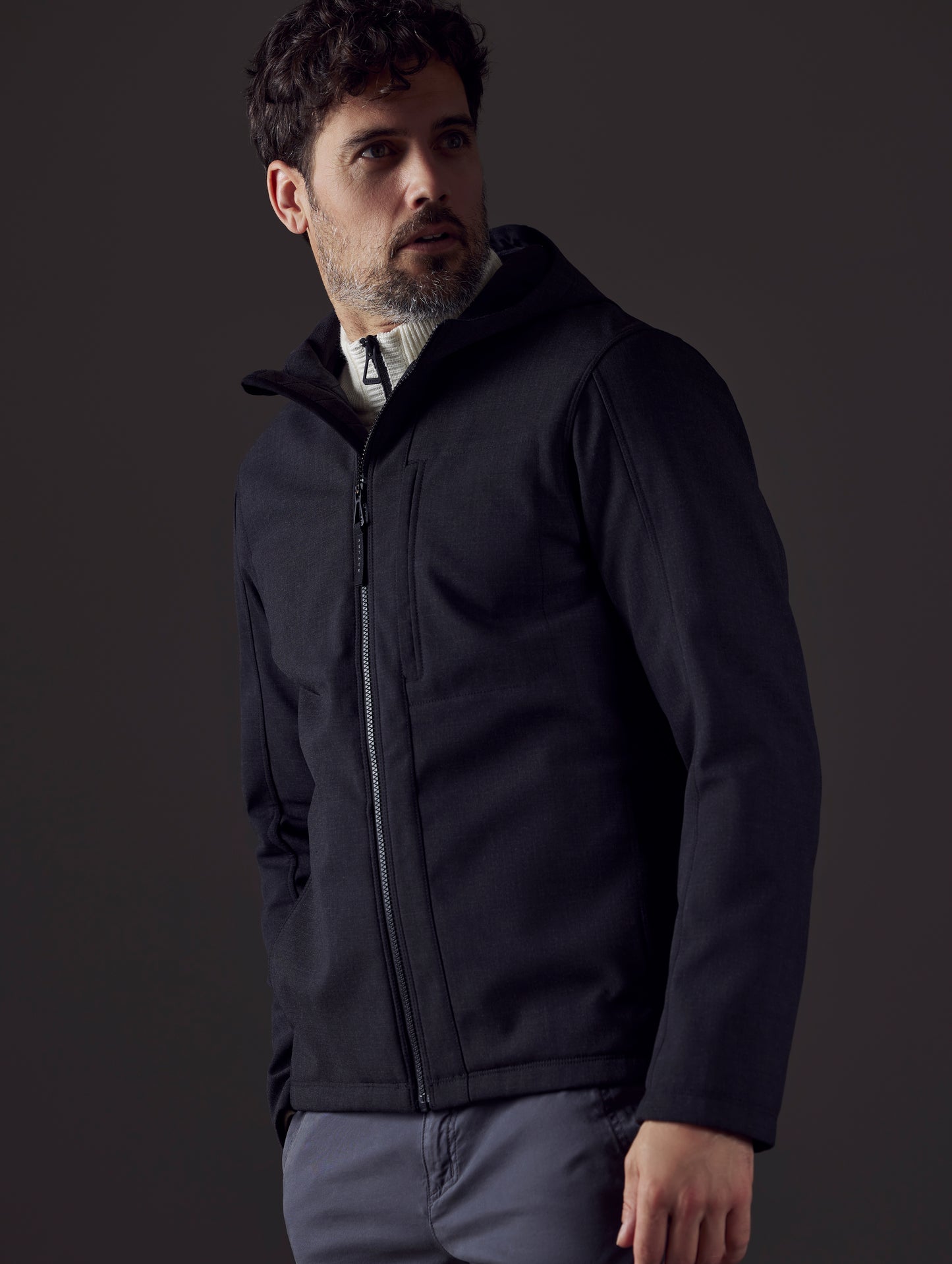 Man wearing dark grey technical jacket from AETHER Apparel