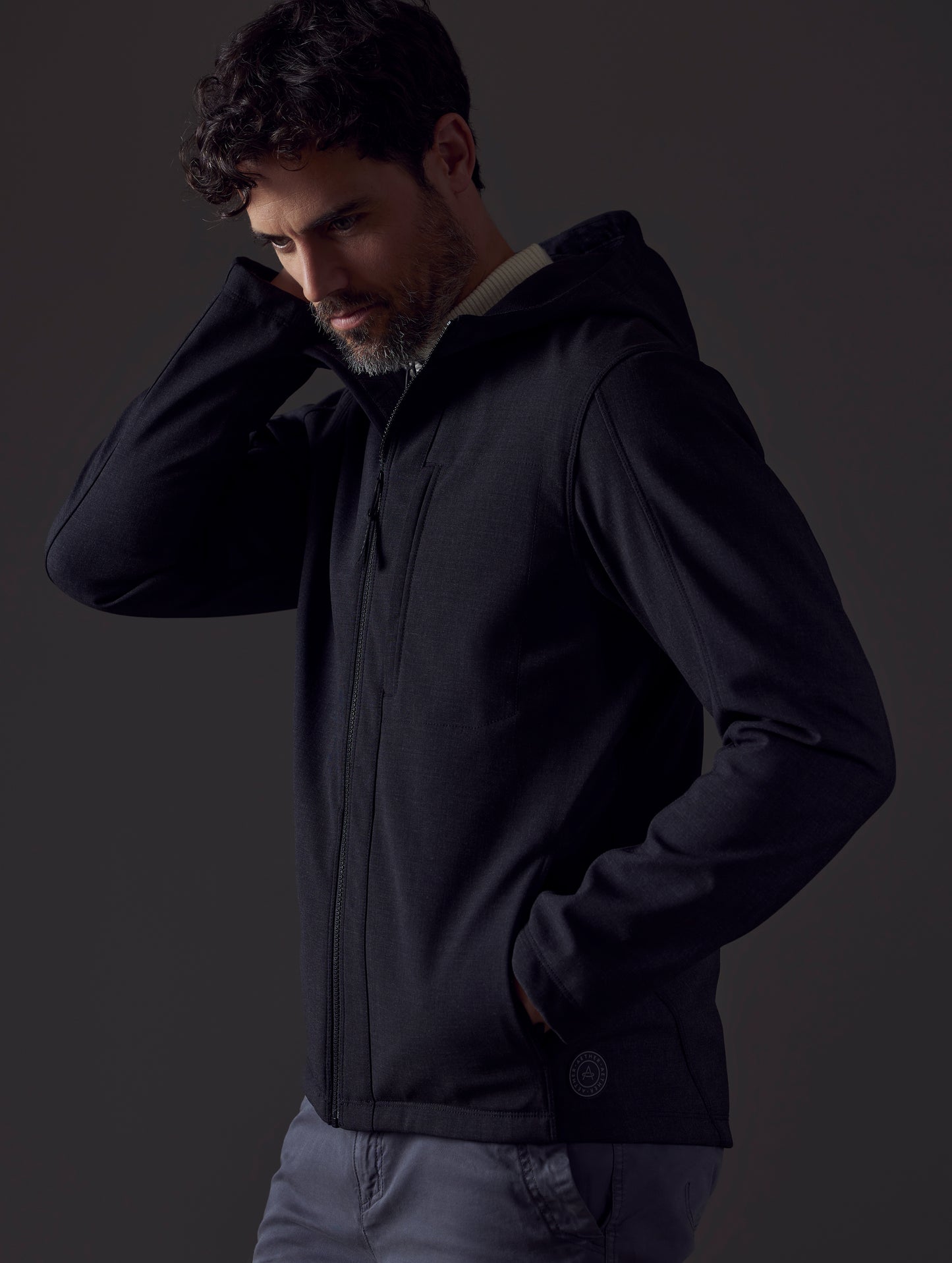 Man wearing dark grey technical jacket from AETHER Apparel