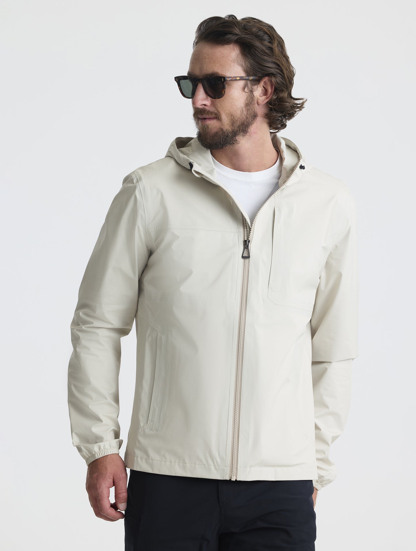 Front view of man wearing Storm All-Weather Jacket in Bone white from AETHER Apparel.