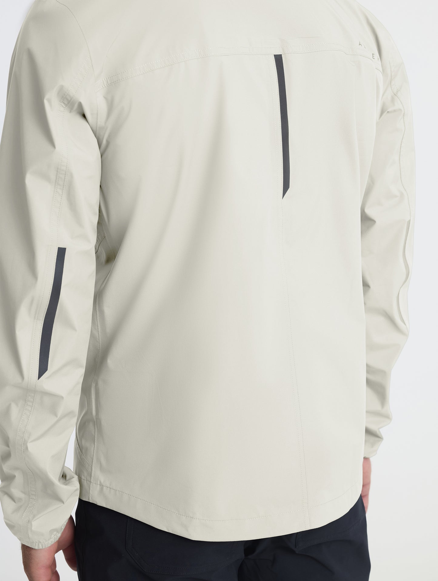 Closeup of rear self-packing zipper of Storm All-Weather Jacket in Bone white from AETHER Apparel.
