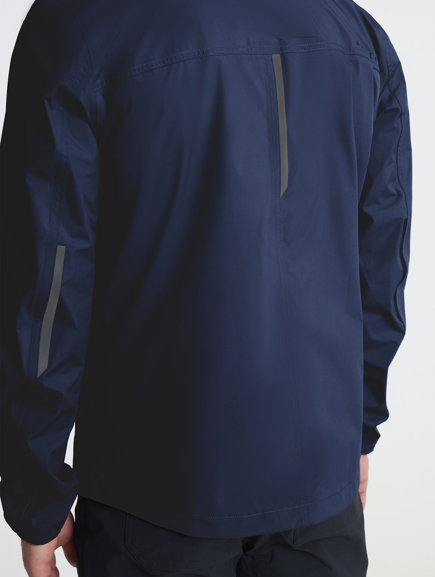 Closeup of rear self-packing zipper of Storm All-Weather Jacket in Total Eclipse dark blue from AETHER Apparel.