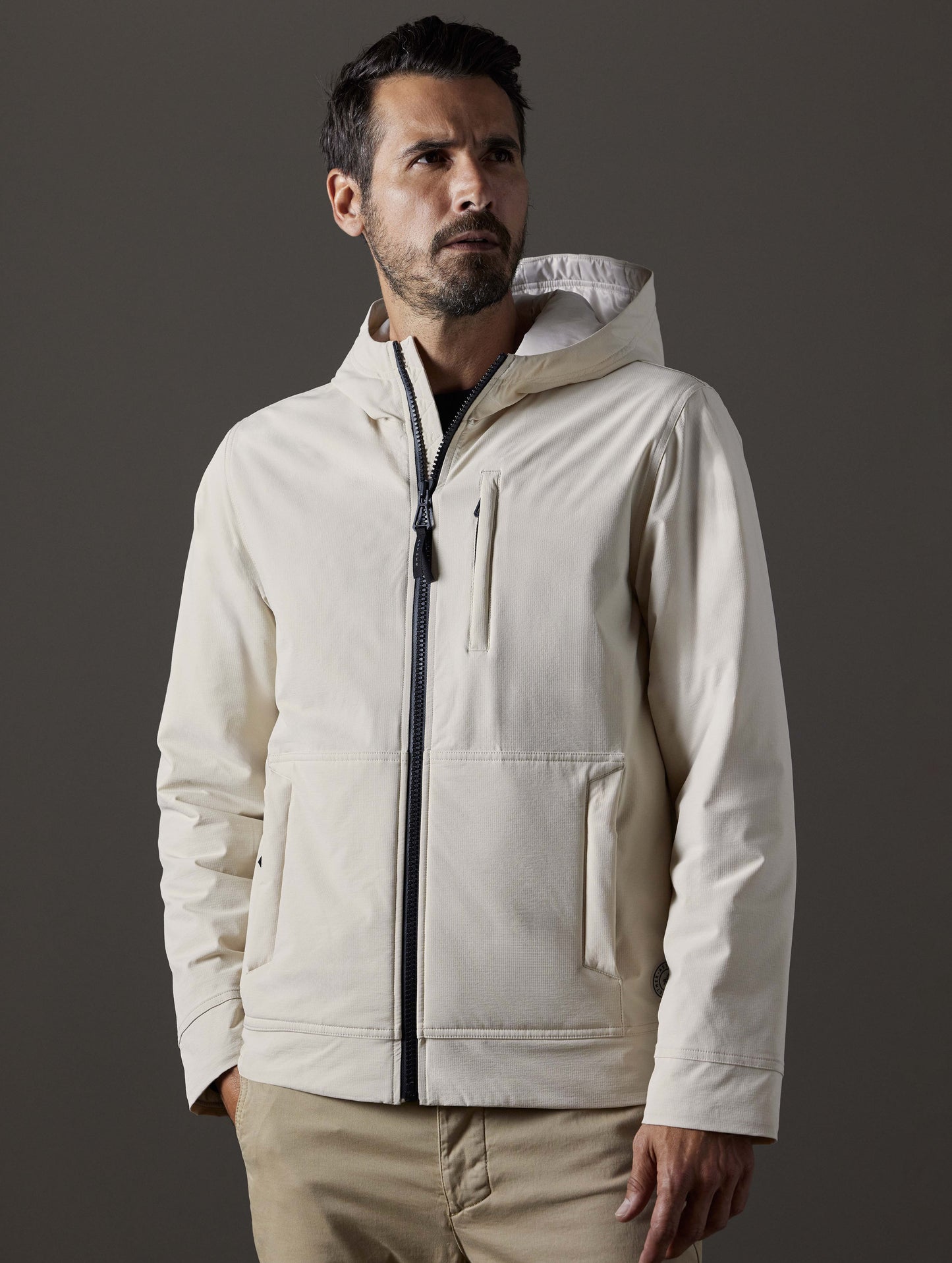 Front body view of man wearing Stornaway Insulated Hoodie in Bone white from AETHER Apparel.