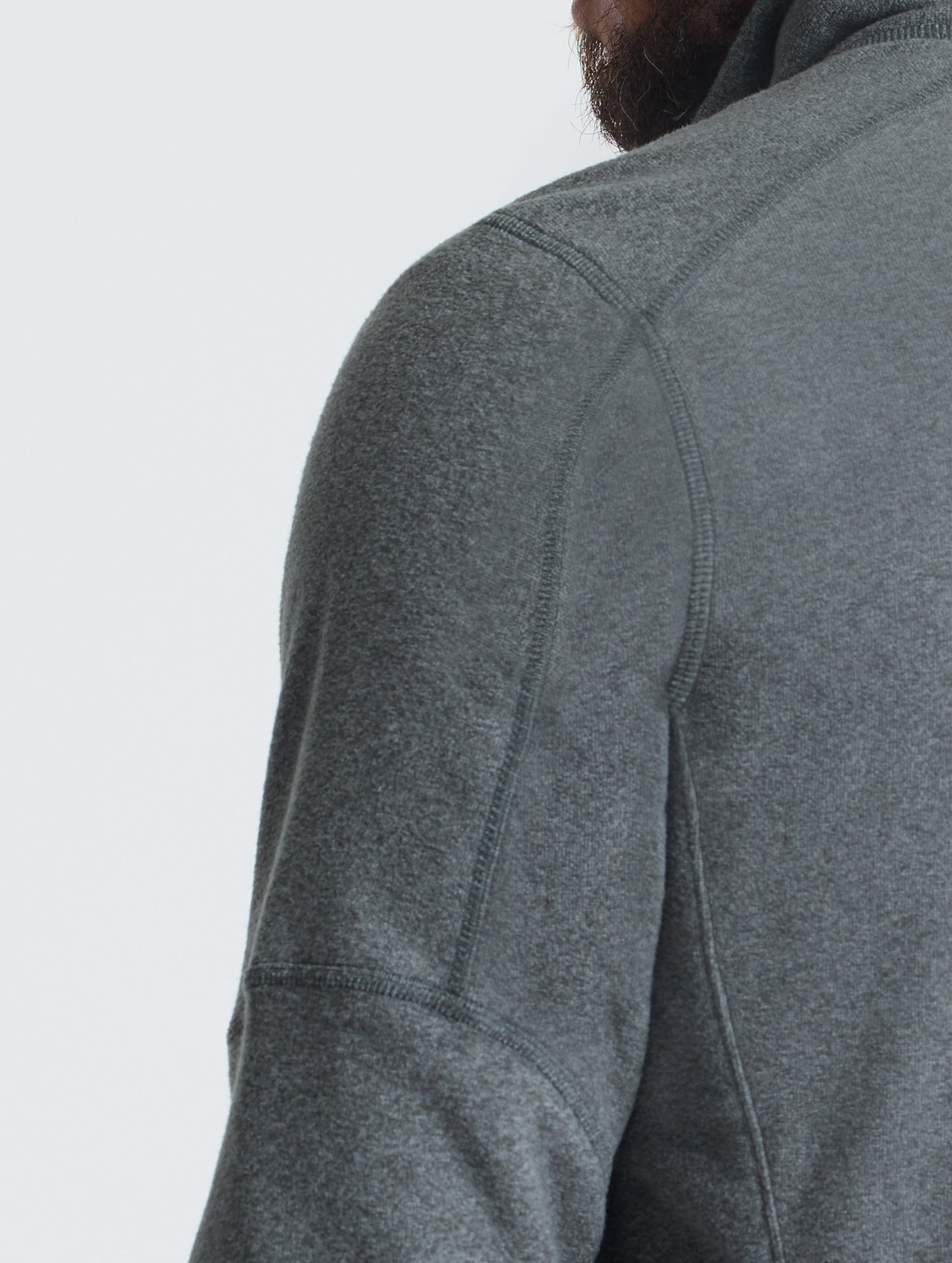 Closeup rear view of wearer's shoulder of Sutherlin Full-Zip in Charcoal Grey from AETHER Apparel.