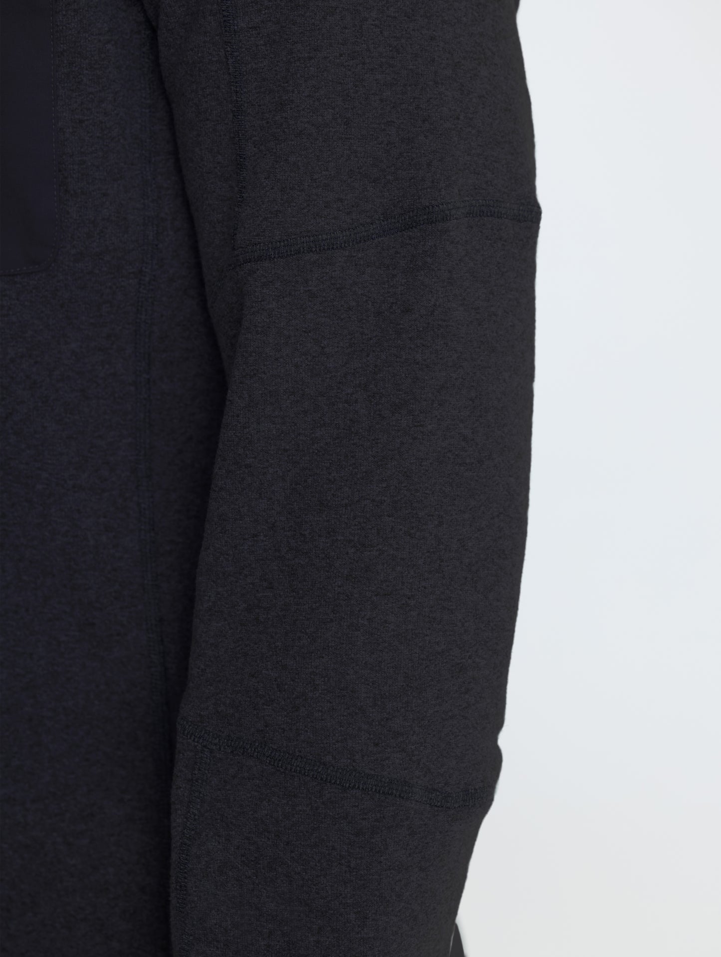 Closeup rear view of right sleeve of Sutherlin Half-Zip in Onyx Black from AETHER Apparel.
