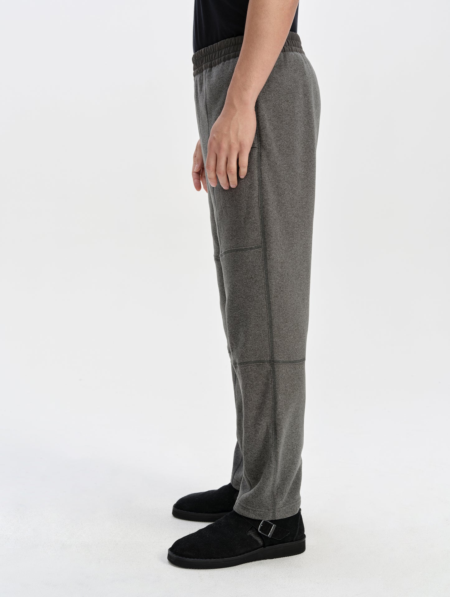 Side profile lower-body view of man wearing the Sutherlin Pant in Charcoal Grey from AETHER Apparel.