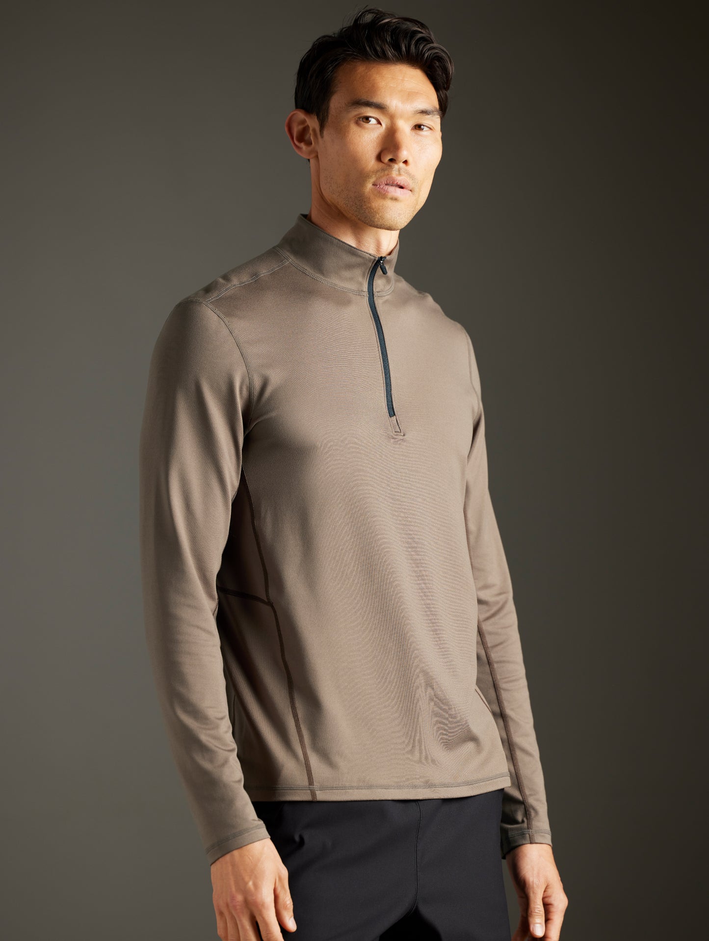 Front 3/4 body view of man wearing Trek Articulated Half-Zip Tee in Cadet Green from AETHER Apparel.