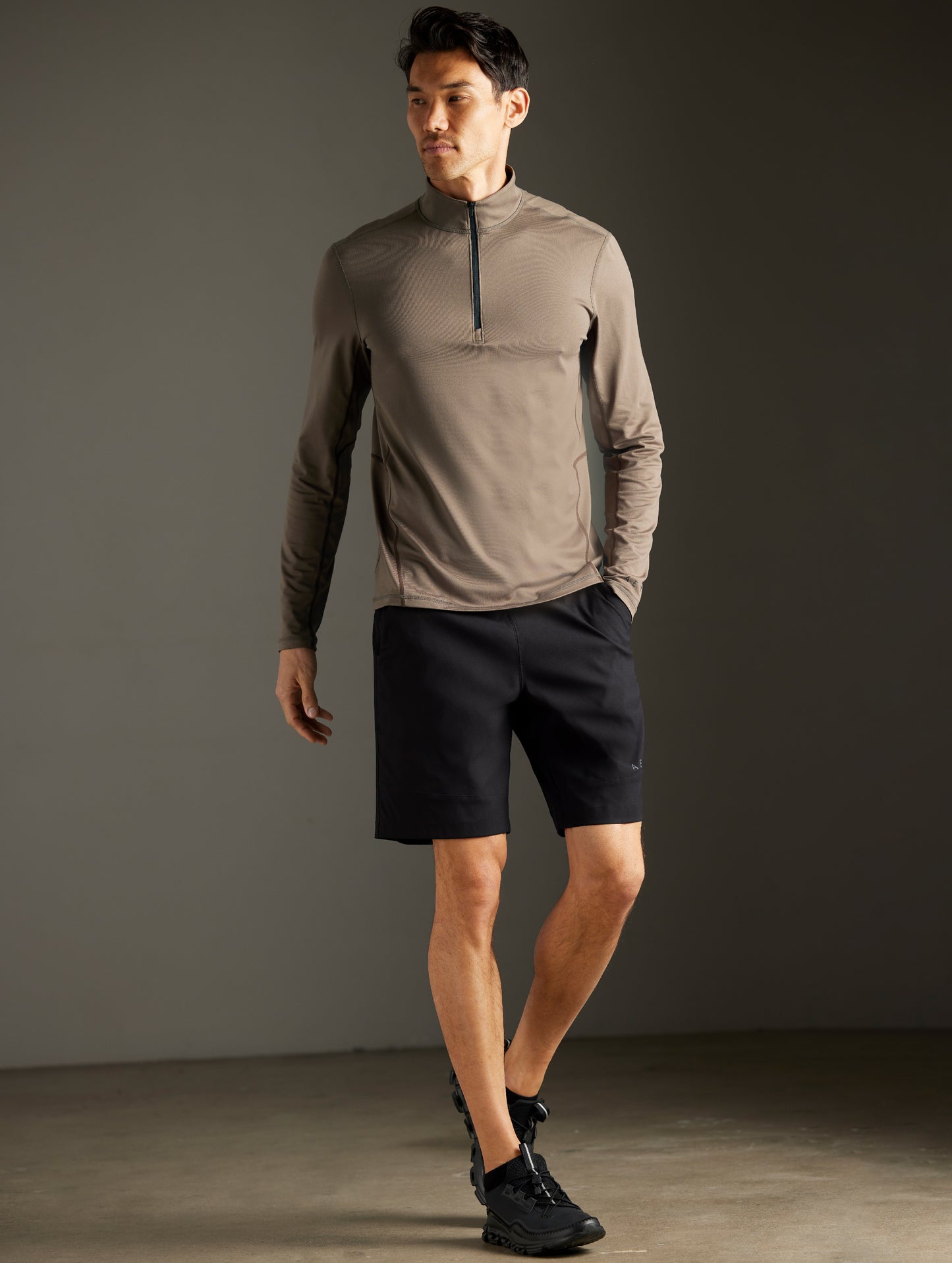 Front full-body view of man wearing Trek Articulated Half-Zip Tee in Cadet Green from AETHER Apparel.