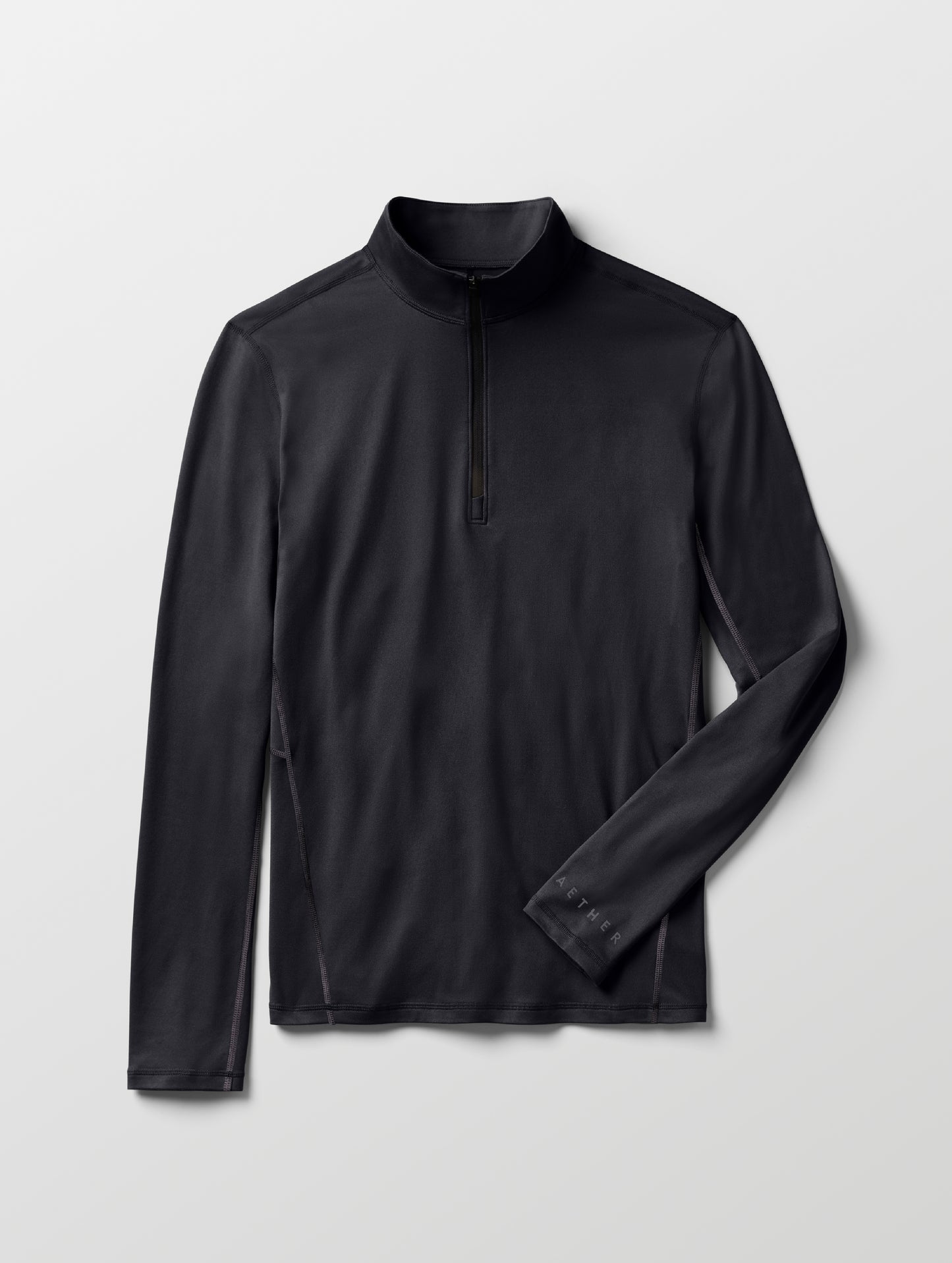 Flat lay of Trek Articulated Half-Zip Tee in Onyx Black from AETHER Apparel.