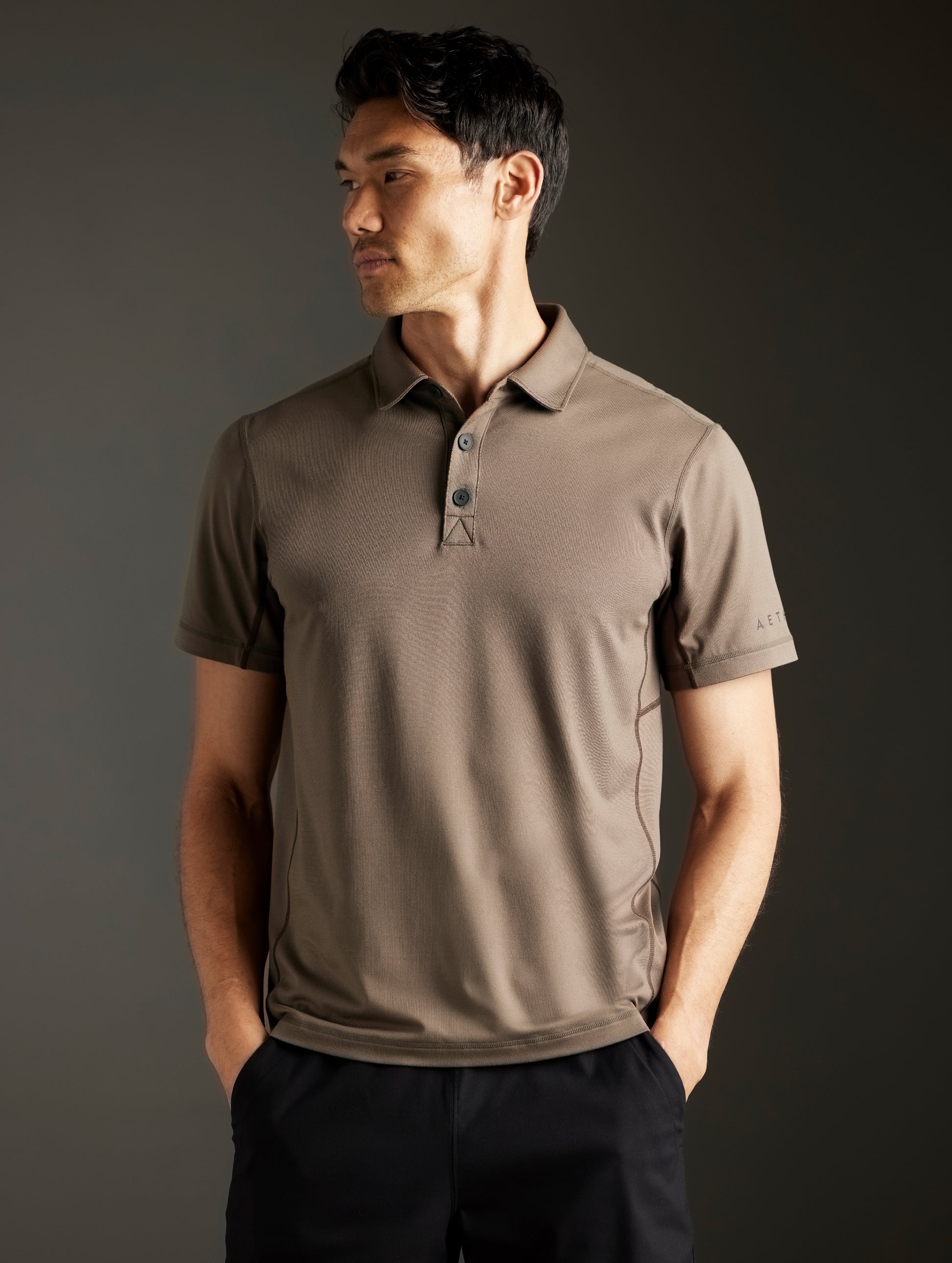 Front body view of man wearing Trek Articulated Polo in Cadet Green from AETHER Apparel.