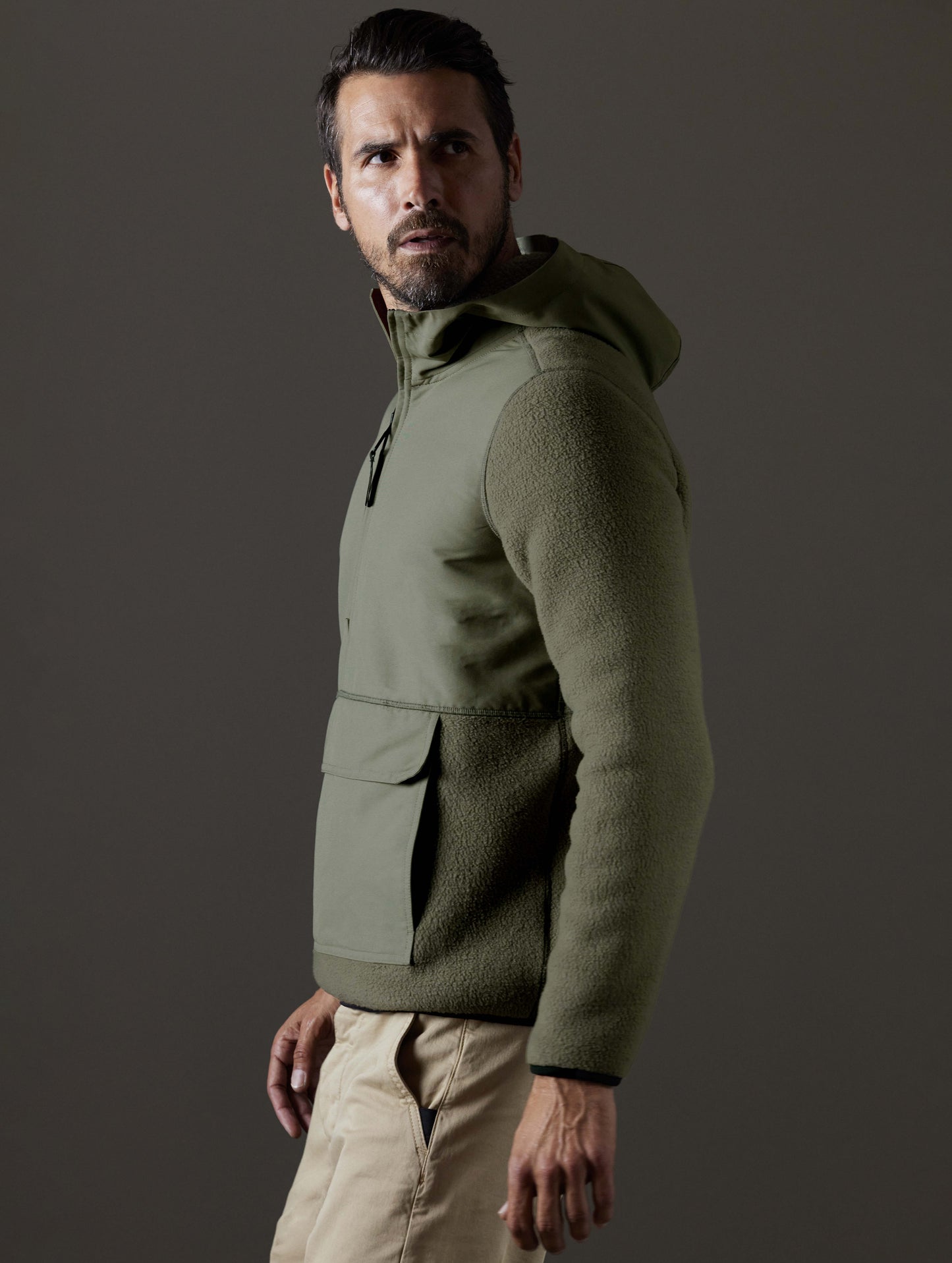 Side profile body view of man wearing Walsh Hooded Anorak in Fern Green from AETHER Apparel.