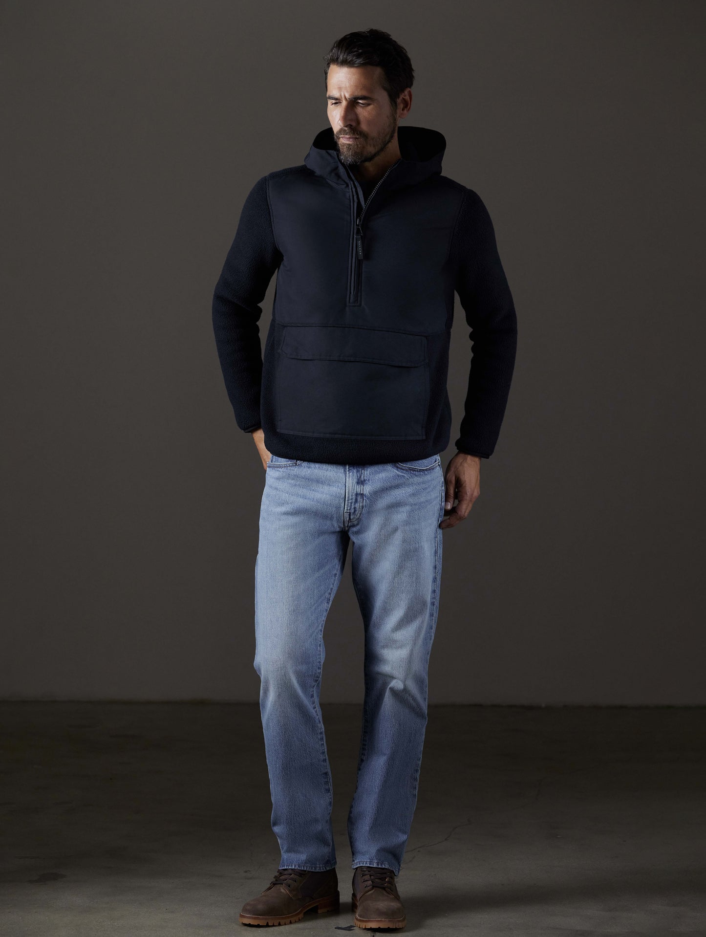 Front full-body view of man wearing Walsh Hooded Anorak in Onyx Black from AETHER Apparel.