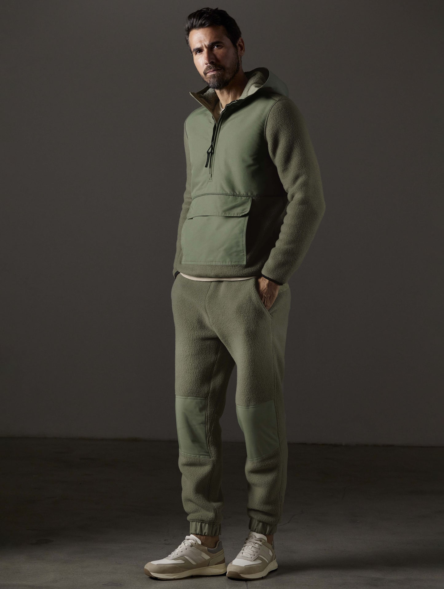 Front 3/4 full-body view of man wearing Walsh Pant in Fern Green from AETHER Apparel.