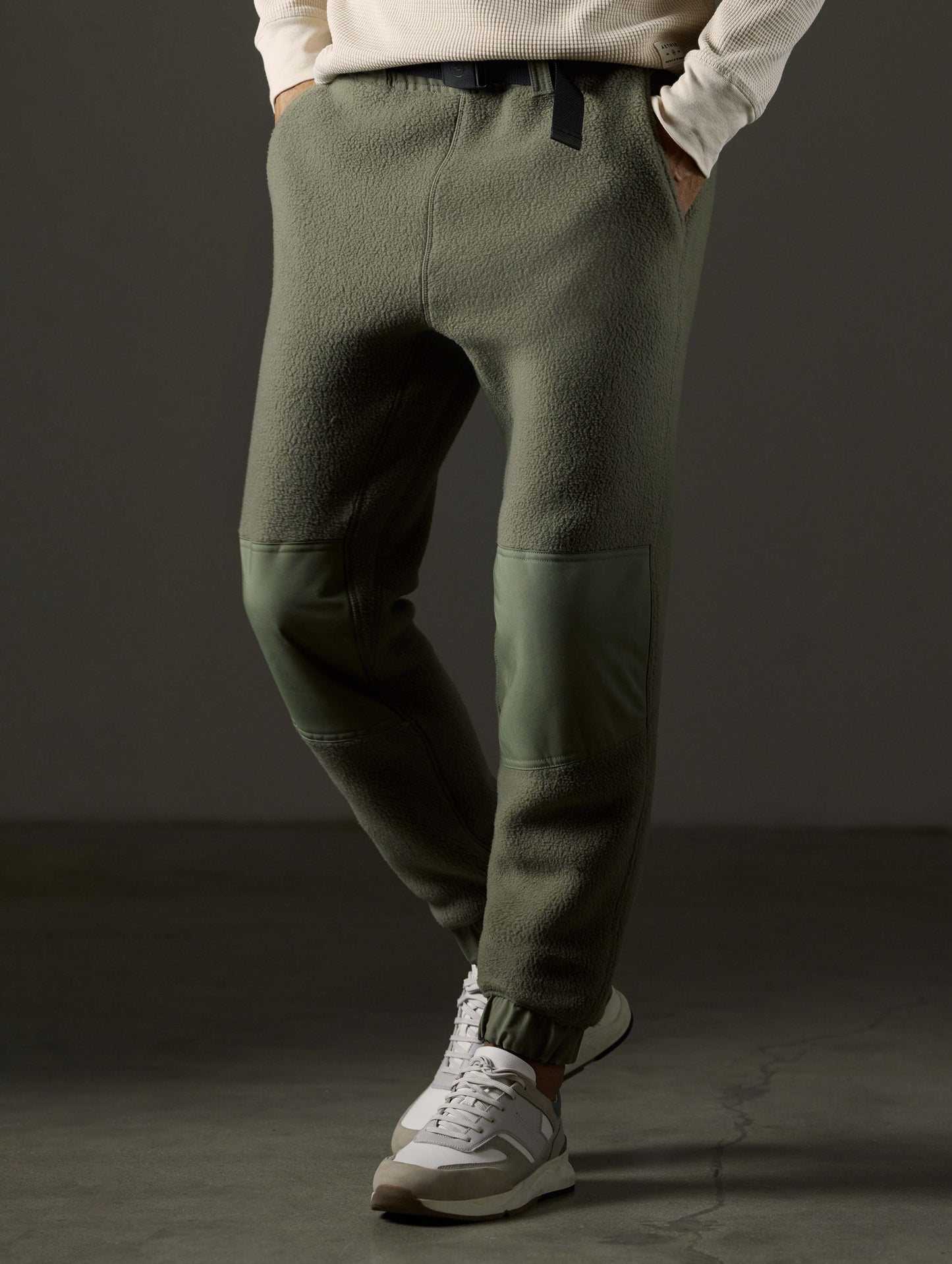 Front 3/4 body view of man wearing Walsh Pant in Fern Green from AETHER Apparel.
