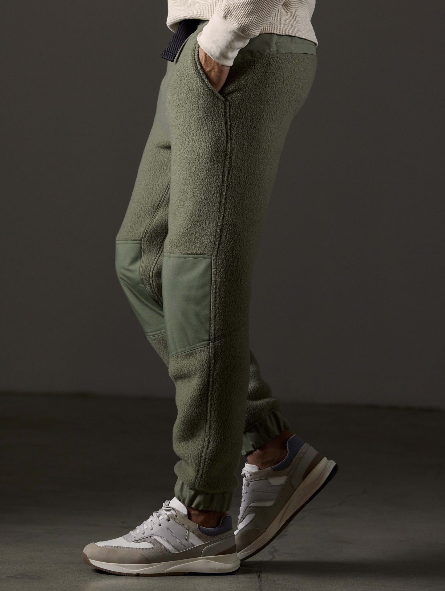 Side profile lower body view of man wearing Walsh Pant in Fern Green from AETHER Apparel.