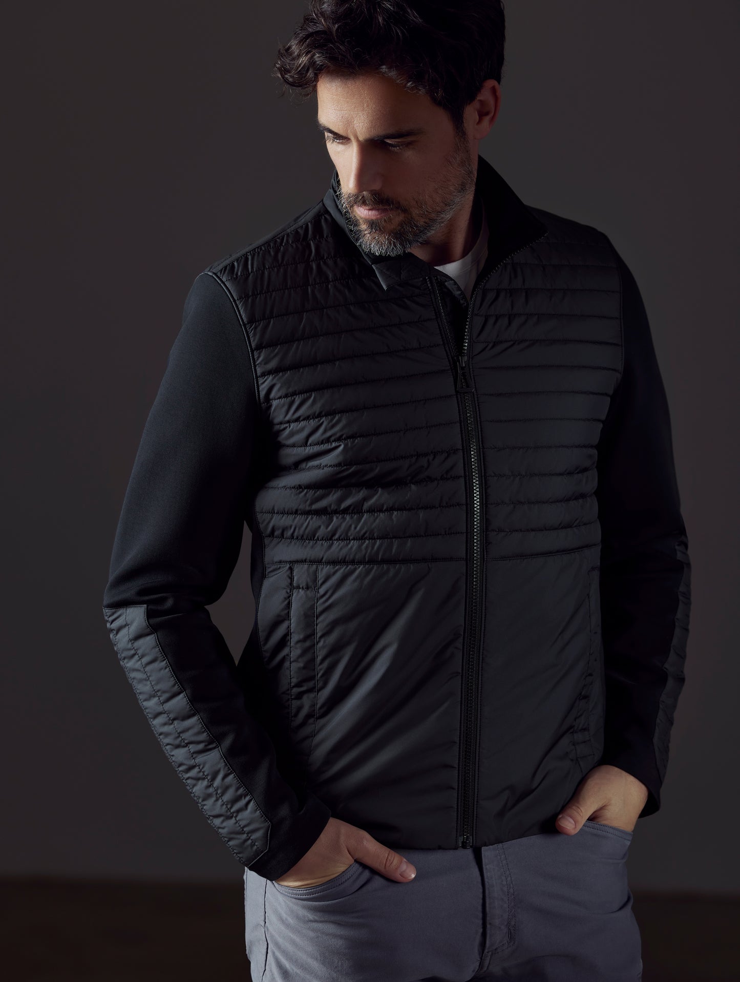 Man wearing black technical jacket from AETHER Apparel