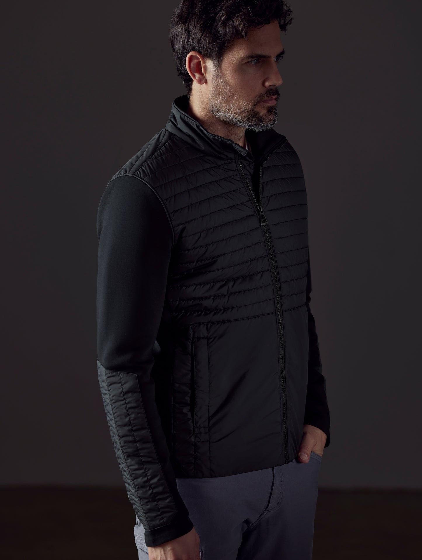 Man wearing black technical jacket from AETHER Apparel
