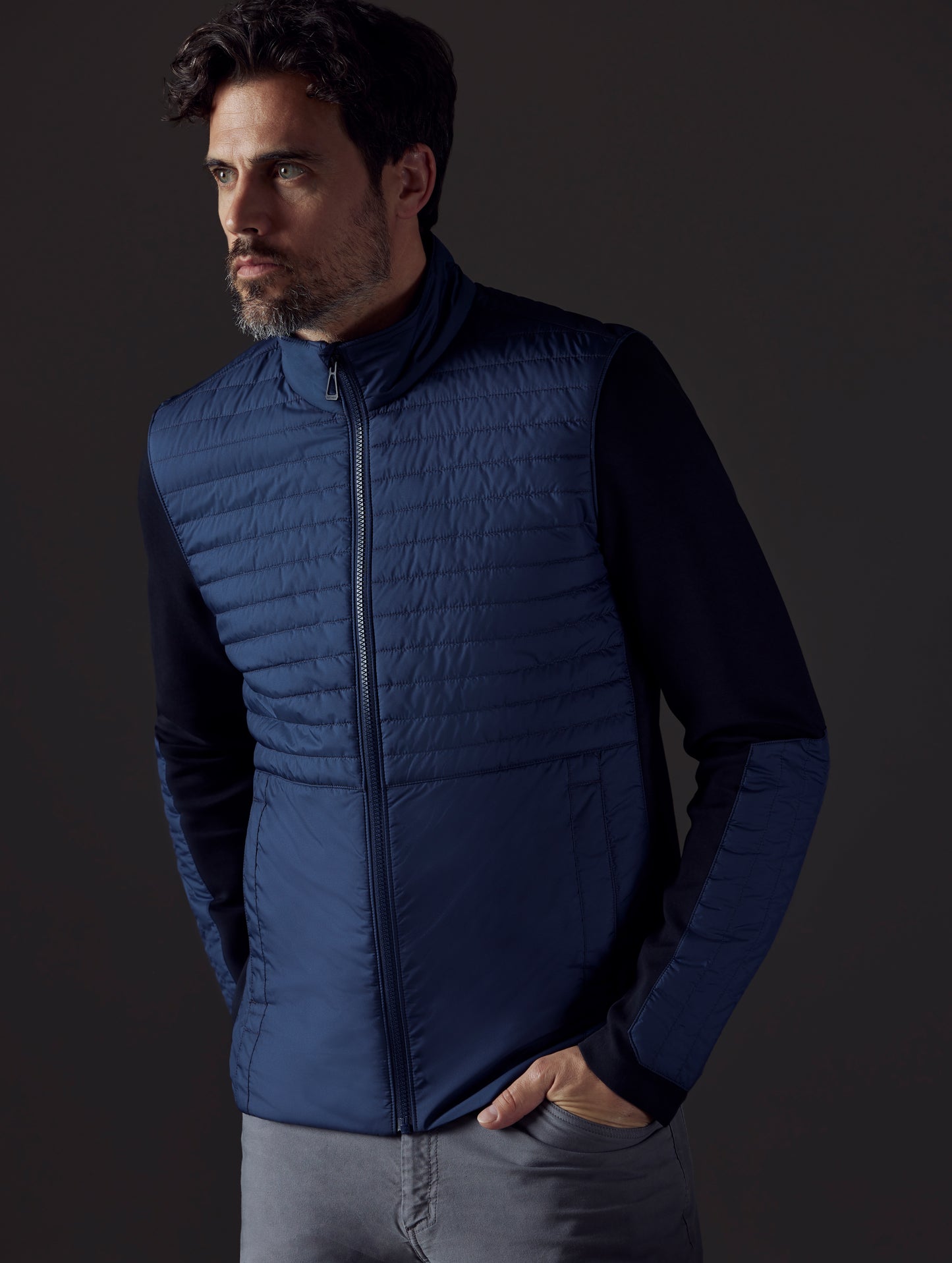 Front body view of man wearing Watts Technical Jacket in Total Eclipse dark blue from AETHER Apparel.