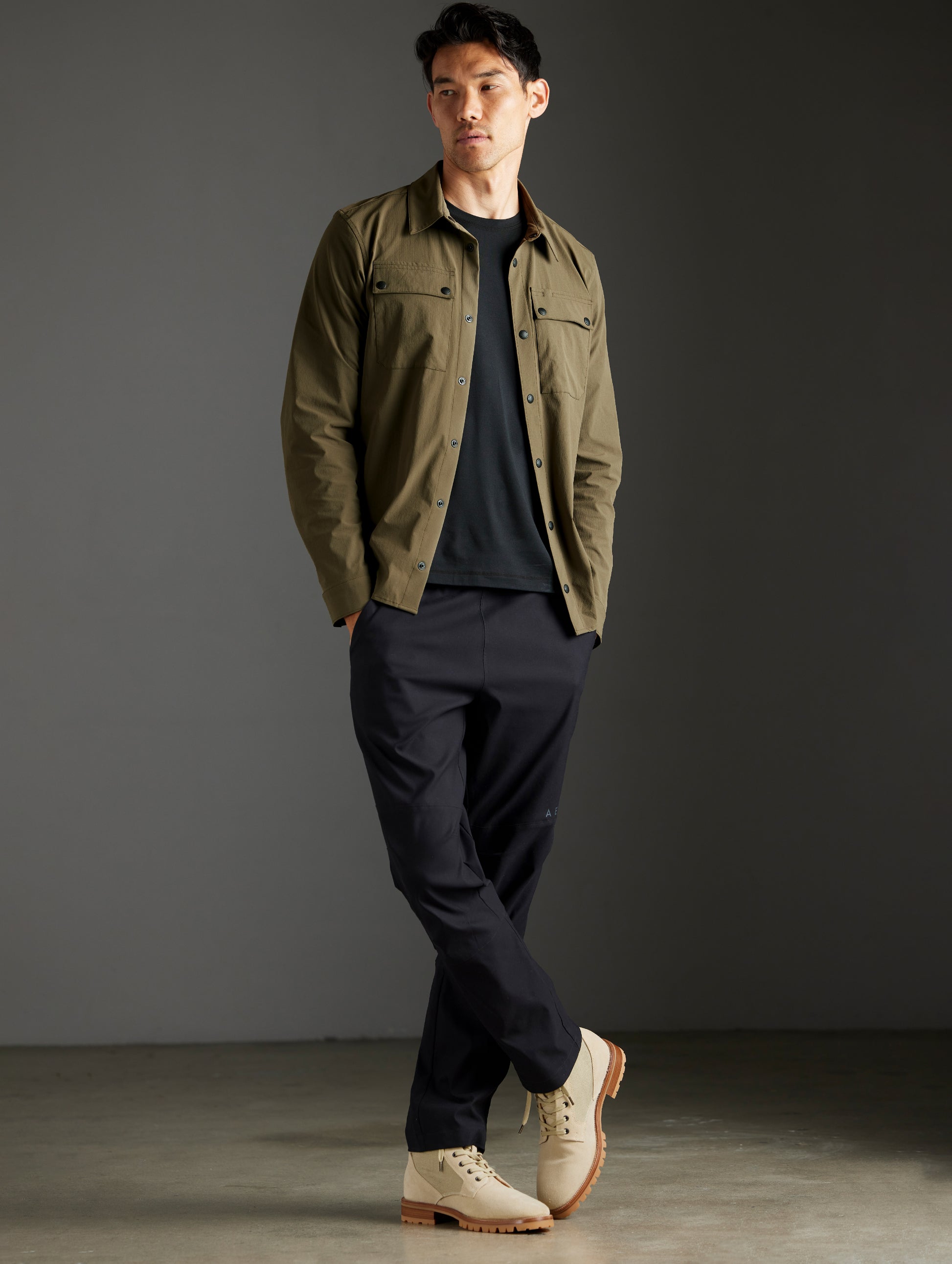 Front full-body view of man wearing Wonder Technical Button-Down in Cadet green from AETHER Apparel.