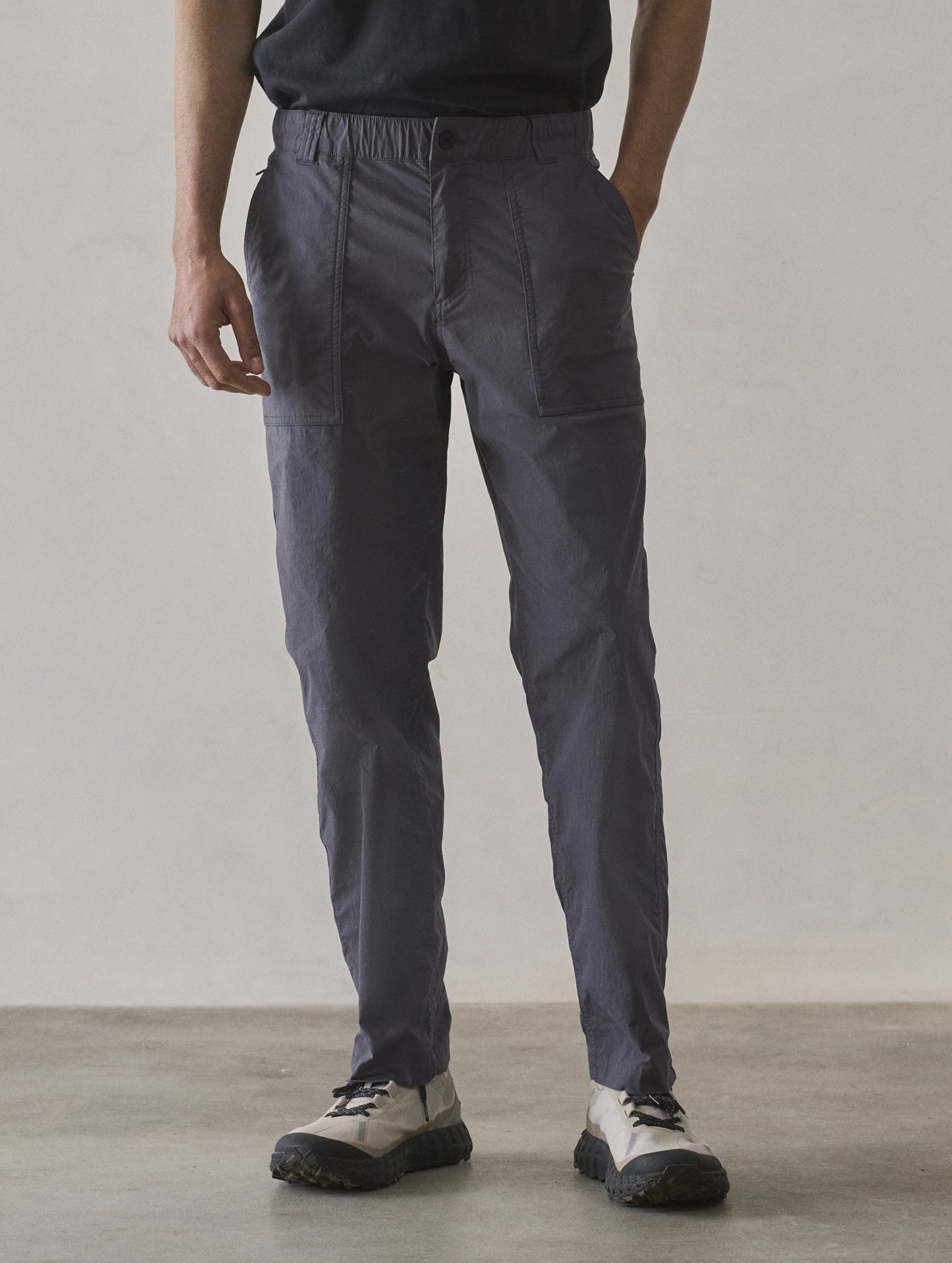 Front lower body view of man wearing Zermatt Hiking Pant in Graphite from AETHER Apparel.