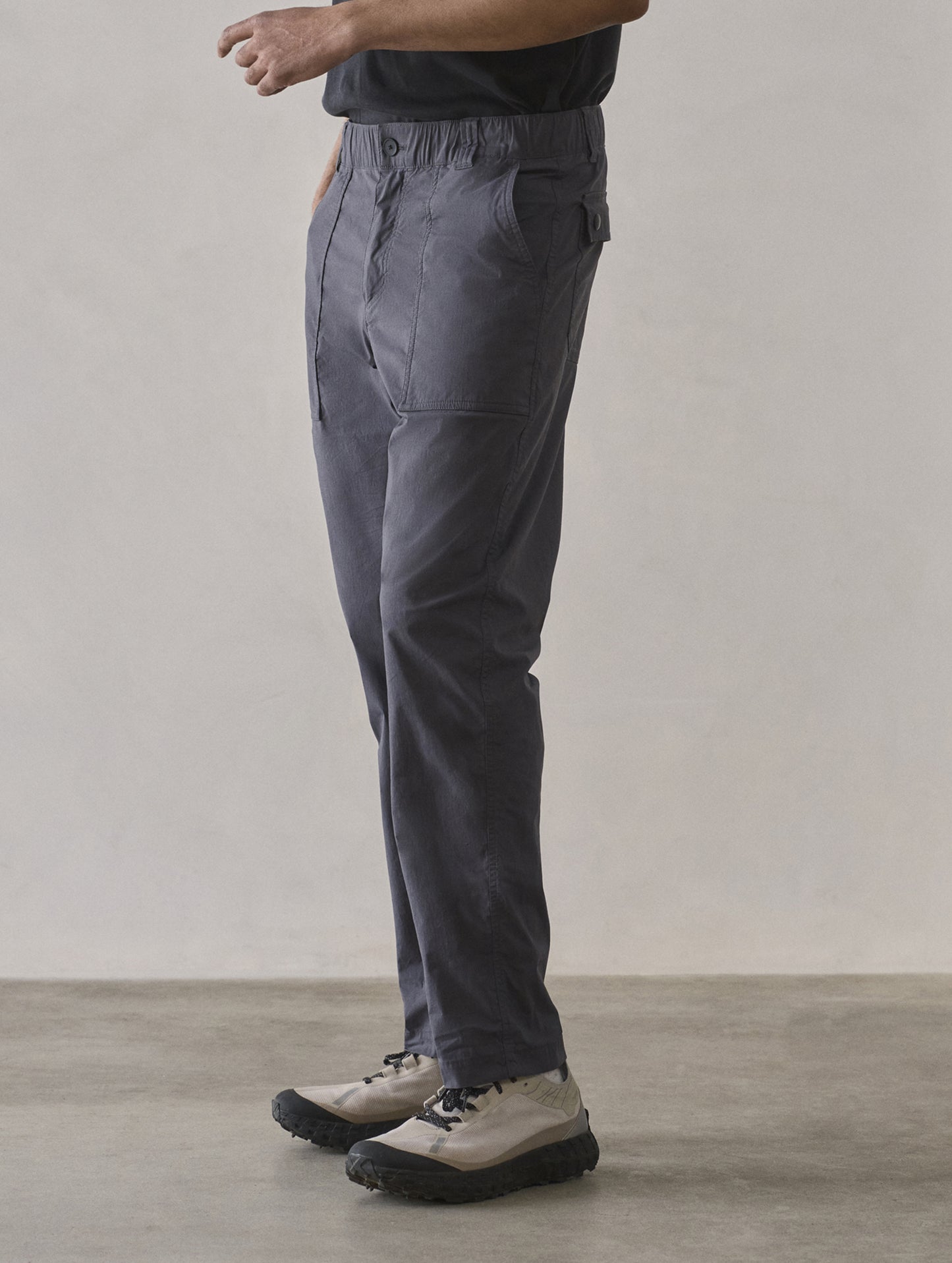 Front 3/4 lower body view of man wearing Zermatt Hiking Pant in Graphite from AETHER Apparel.