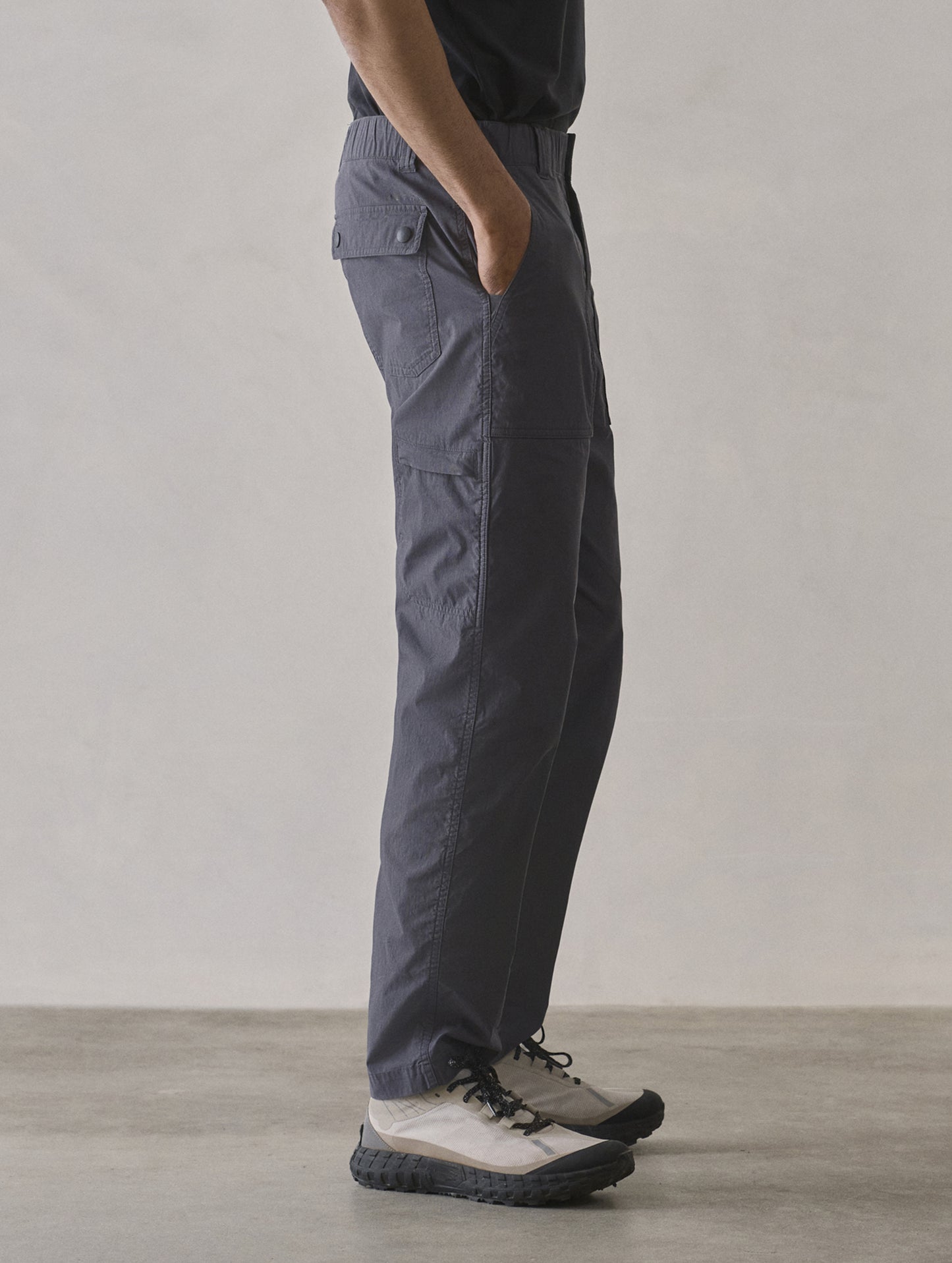 Side profile lower body view of man wearing Zermatt Hiking Pant in Graphite from AETHER Apparel.