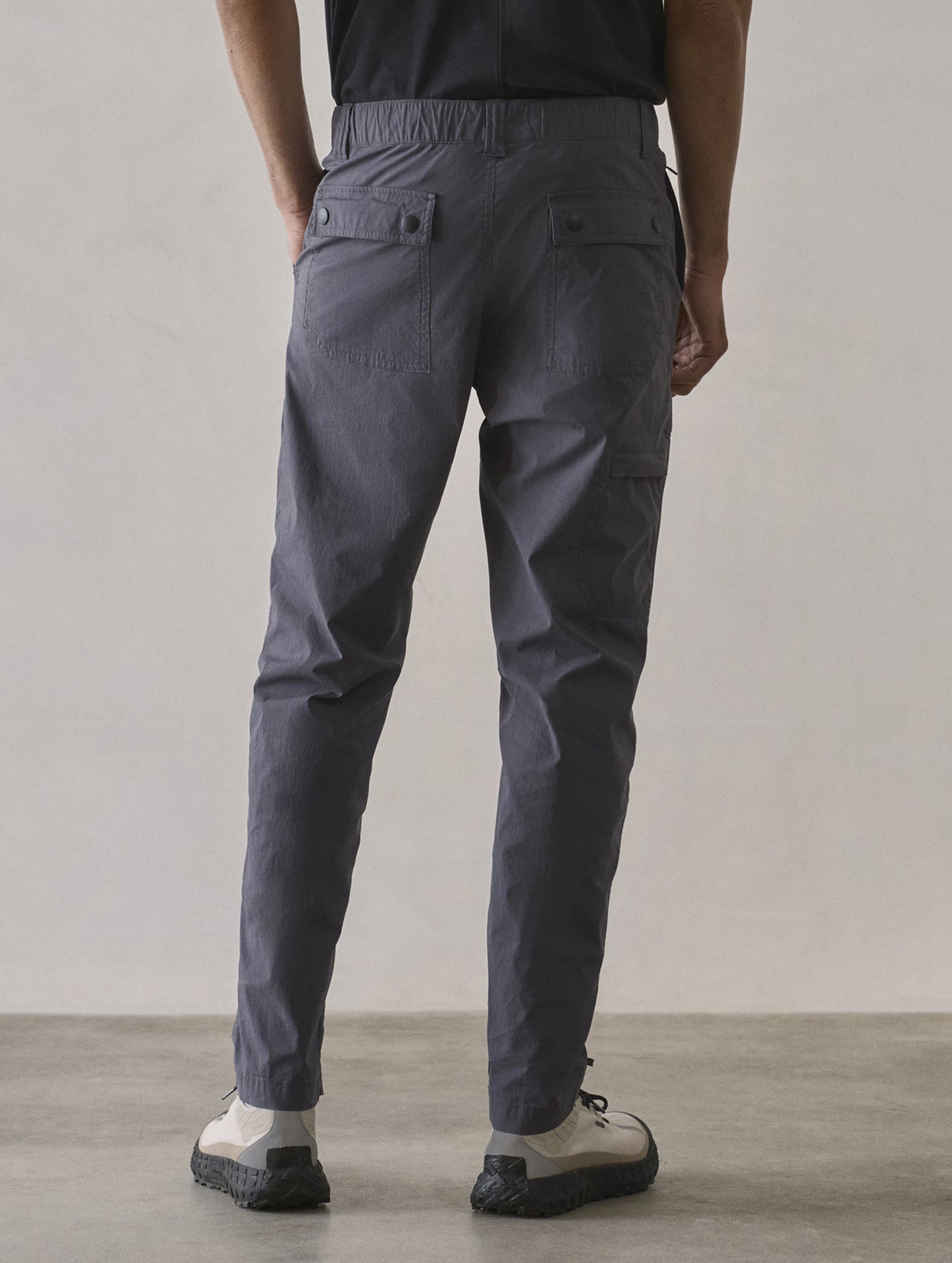 Rear lower body view of man wearing Zermatt Hiking Pant in Graphite from AETHER Apparel.