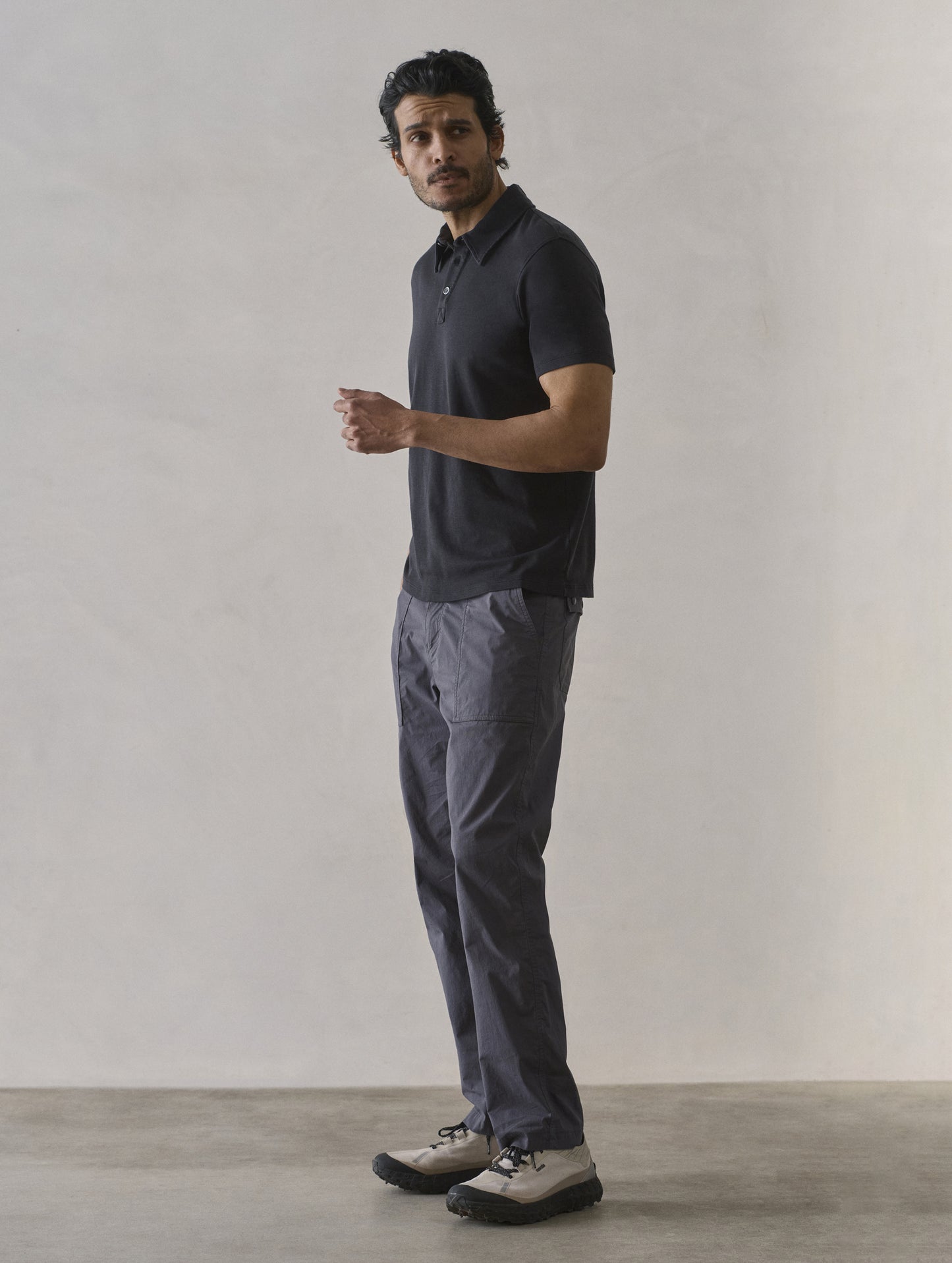 Front 3/4 full-body view of man wearing Zermatt Hiking Pant in Graphite from AETHER Apparel.