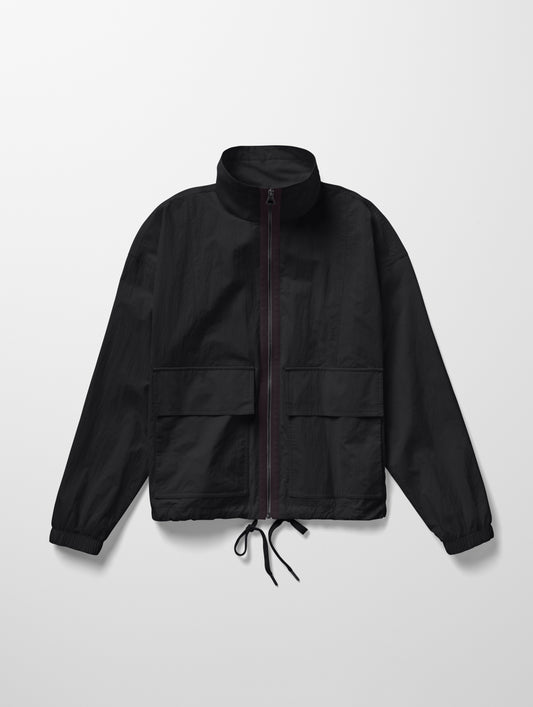 Flat lay image of the Mila Windbreaker in Onyx Black from AETHER Apparel.