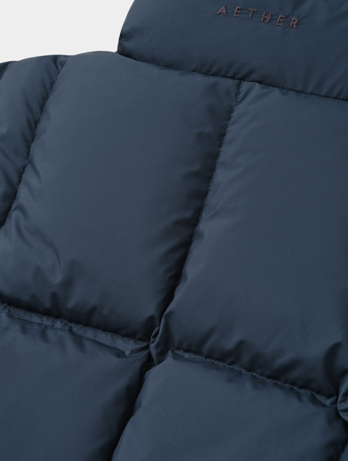Closeup detailed view of the box-quilted back body on Nina Sweater Jacket 2.0 in Total Eclipse from AETHER Apparel.