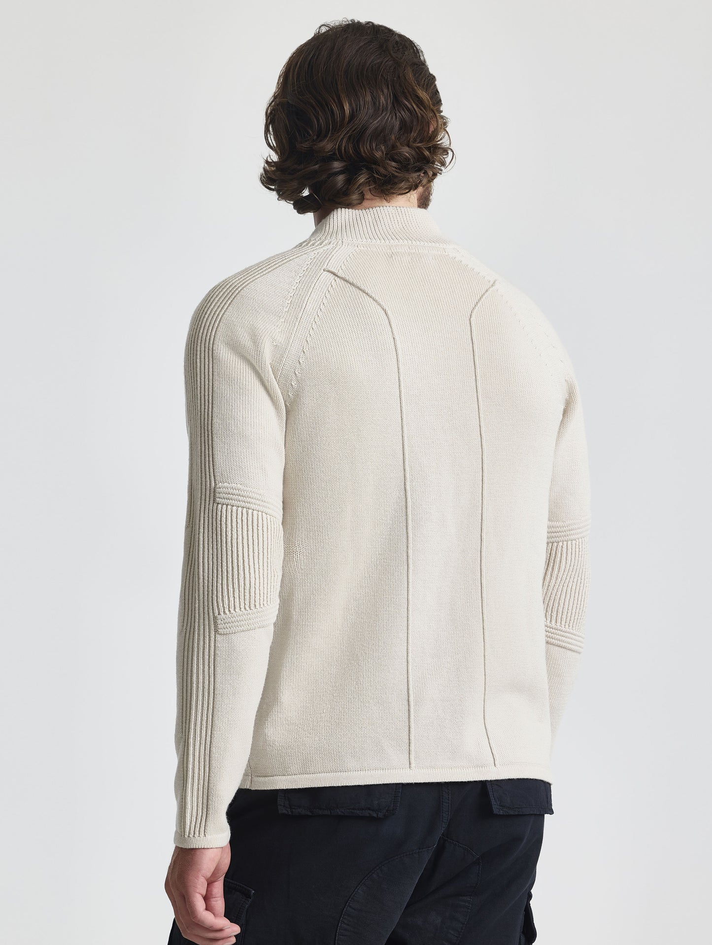 Rear view of man wearing Riley Full-Zip Sweater in Bone white from AETHER Apparel.