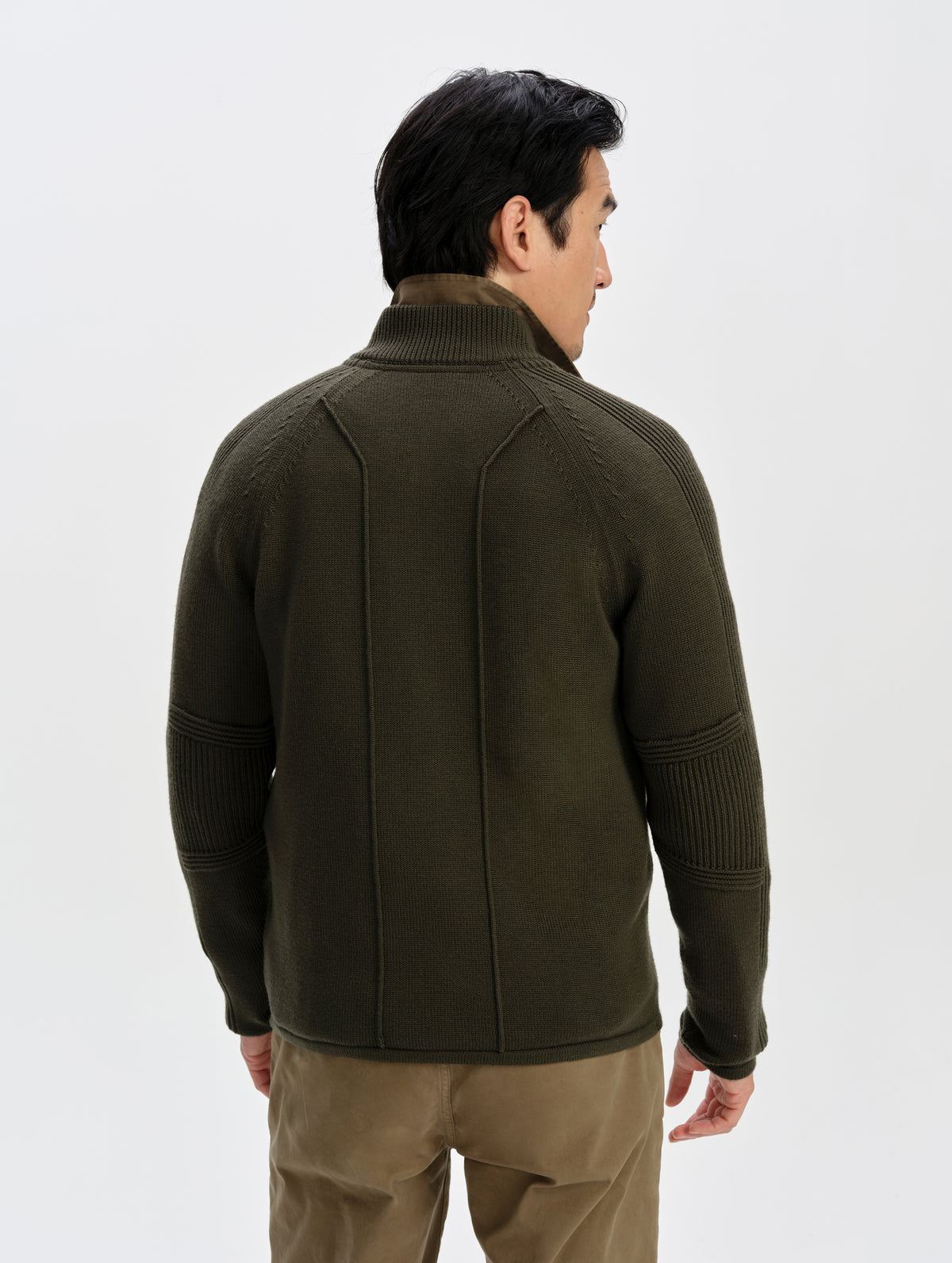 Rear upper-body view of man wearing the Riley Full-Zip Sweater in Forest Green from AETHER Apparel.