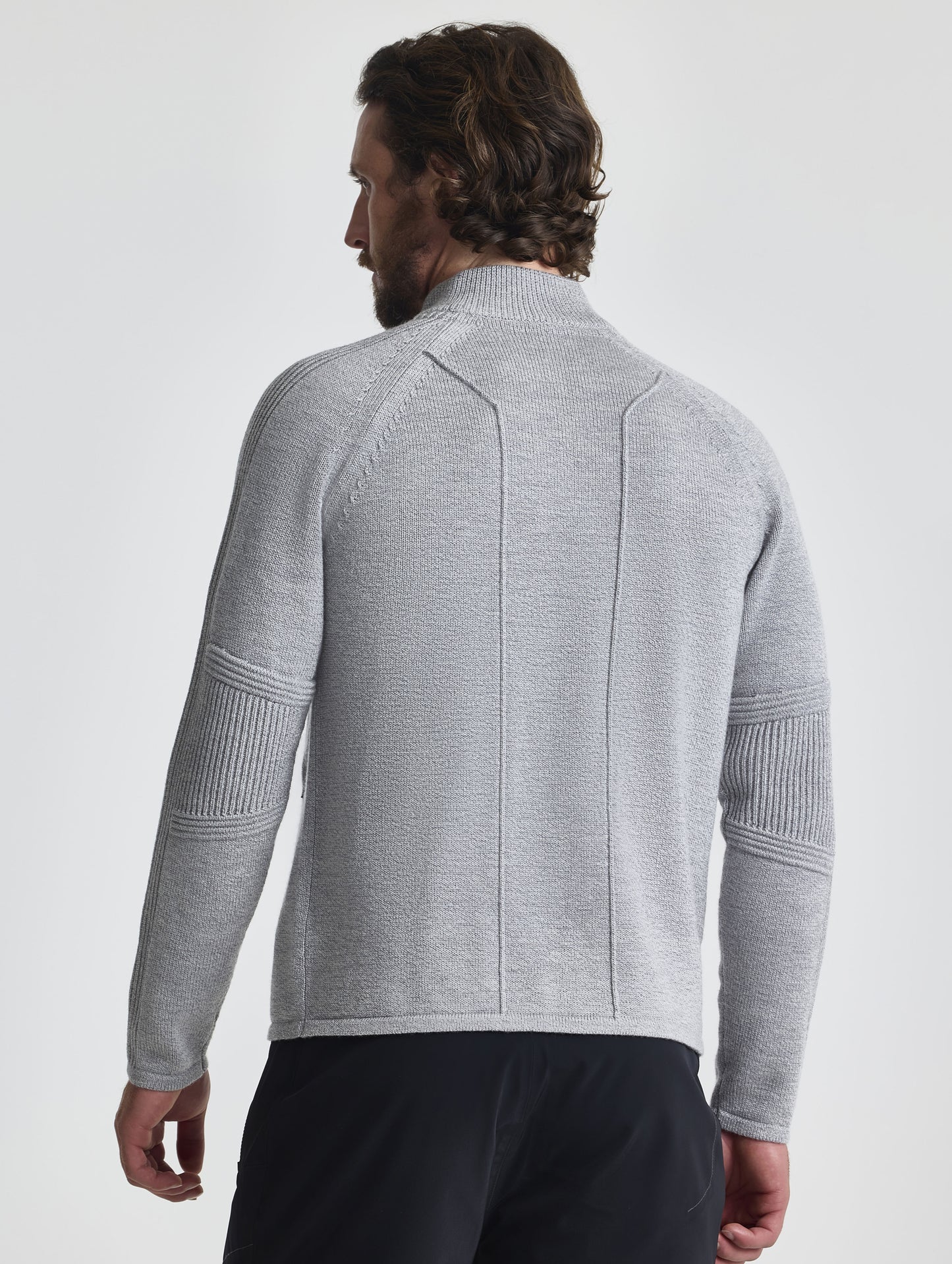 Rear view of man wearing Riley Full-Zip Sweater in Light Heather Grey from AETHER Apparel.