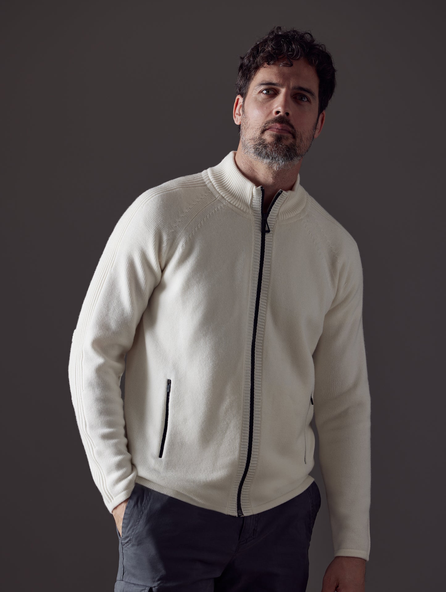 Man wearing white Riley Full-Zip Sweater from AETHER Apparel