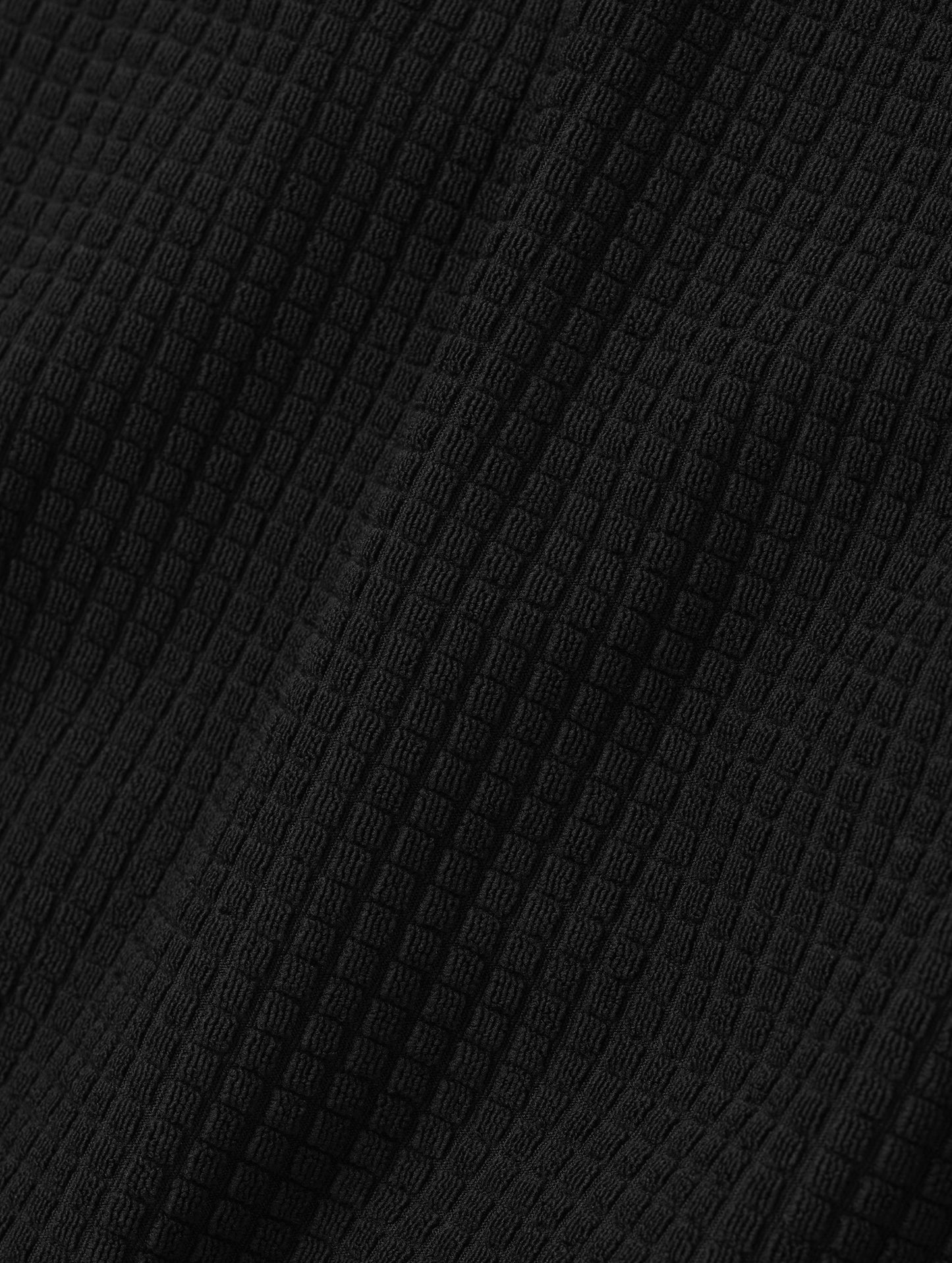 Closeup detailed view of the Check Knit soft fabric on the Rocklin Half-Zip in Onyx Black from AETHER Apparel.
