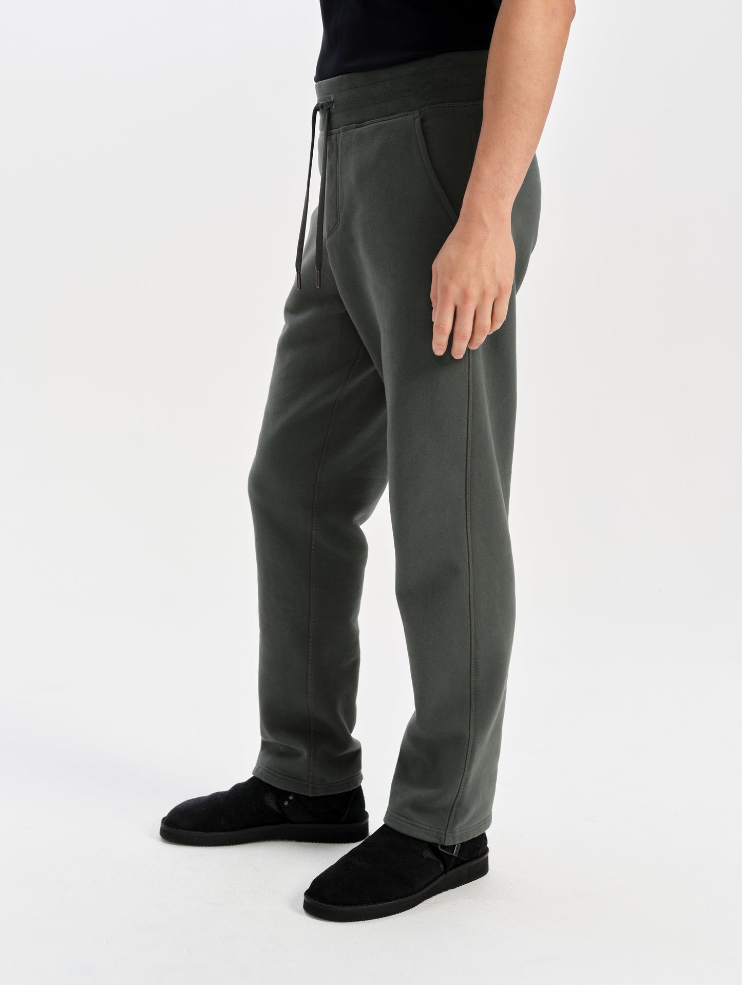 Side profile lower-body view of man wearing the Rylan Sweat Pant in Saville Green from AETHER Apparel.