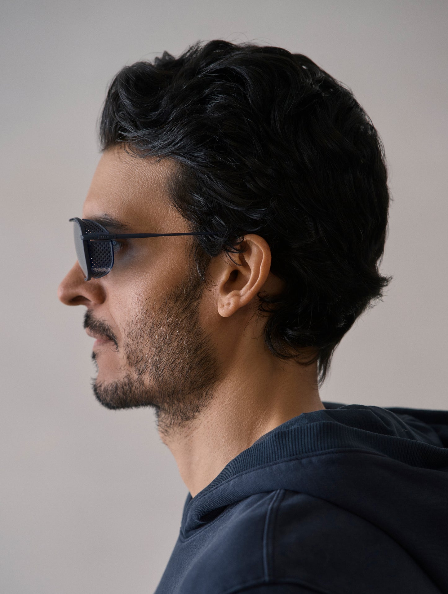 Side profile view of man wearing Summit Sunglass in Blue titanium with Blue Lens from AETHER Apparel.