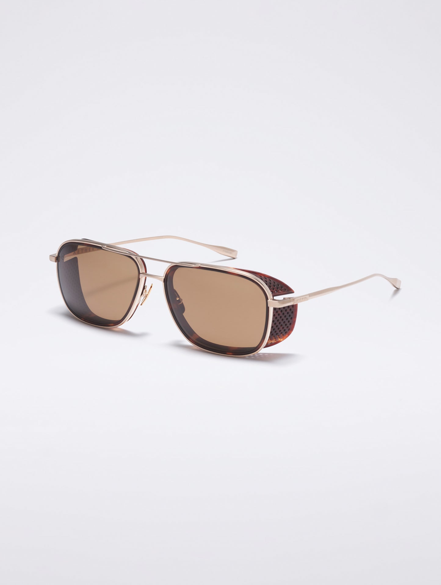 Front 3/4 view of Summit Sunglass in Brushed Gold titanium with G15 Lens from AETHER Apparel.