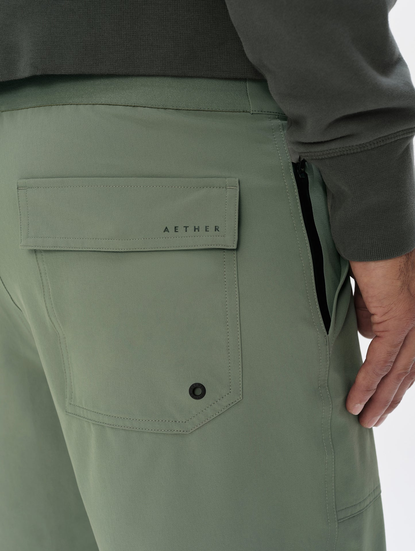 Closeup detailed view of the rear and side zippered pockets on the Velo Short in Gunmetal from AETHER Apparel.