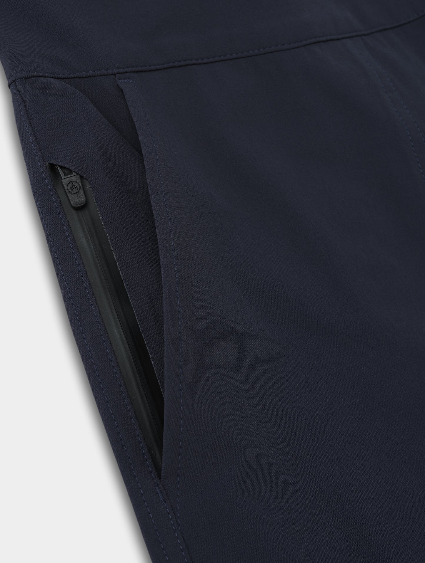 Closeup detailed view of the hand pocket and inner zippered pocket on the Velo Short in Total Eclipse dark blue from AETHER Apparel.