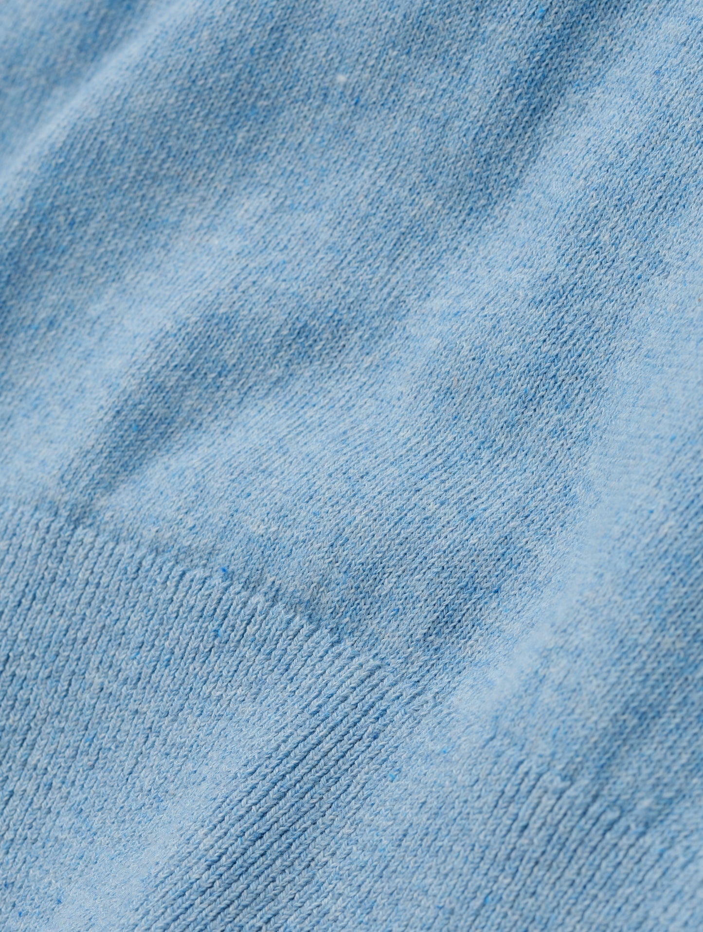 Closeup detailed view of the fabric on the women's Aero Crewneck Sweater 2.0 in Cloud Blue from AETHER Apparel.