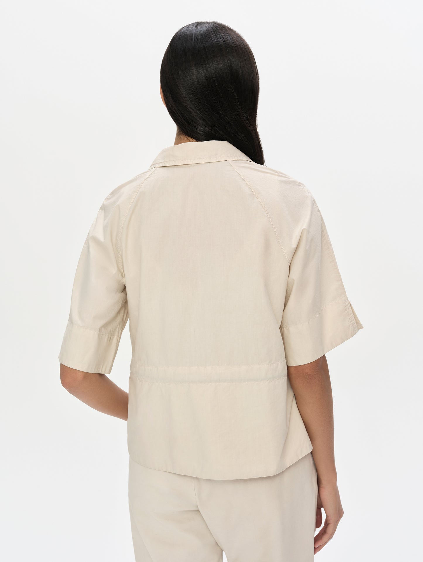 Rear upper body view of woman wearing the Alice Shirt in Bone from AETHER Apparel.