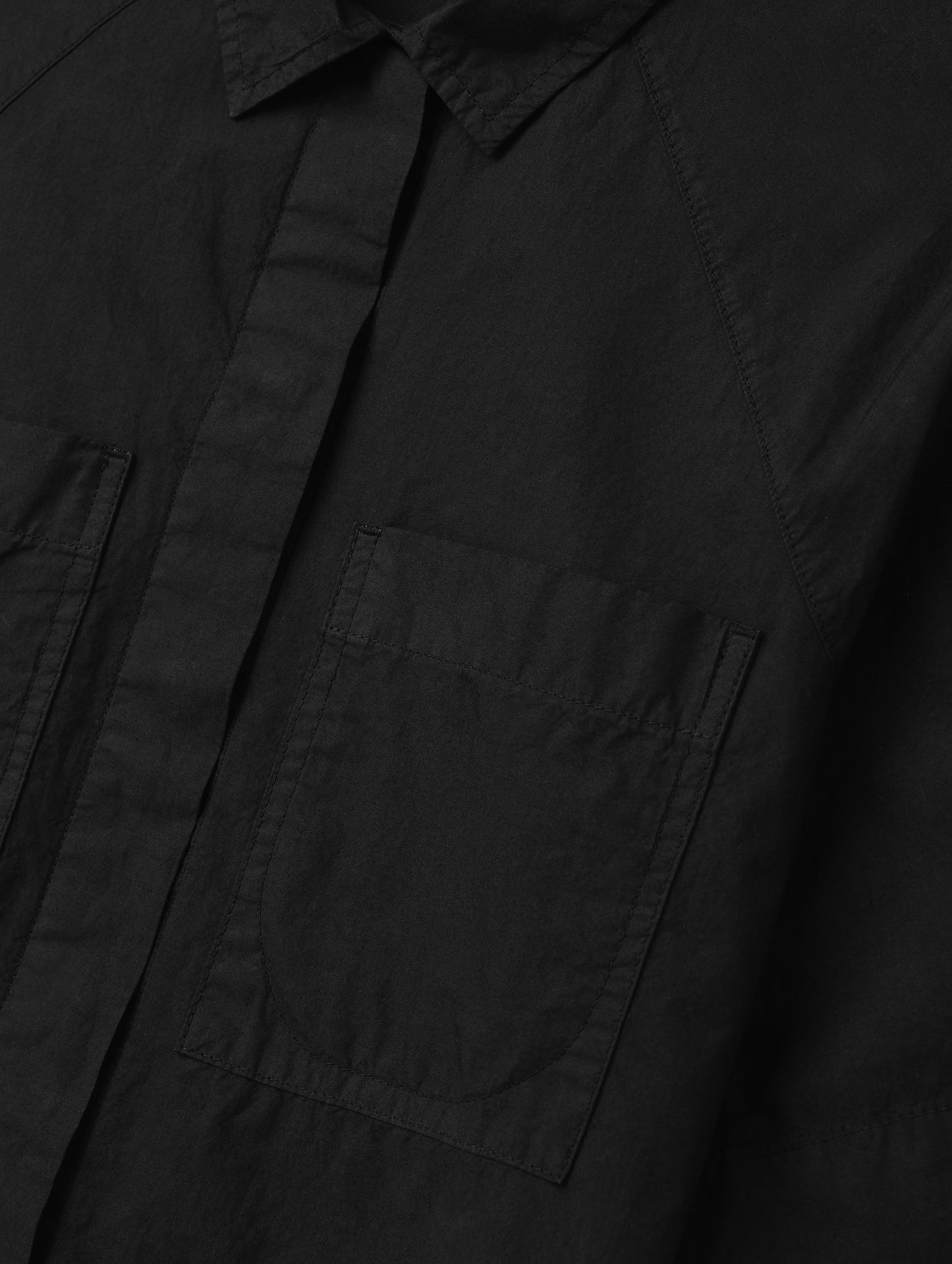 Closeup detailed view of the patch pockets on the Alice Shirt in Onyx Black from AETHER Apparel.
