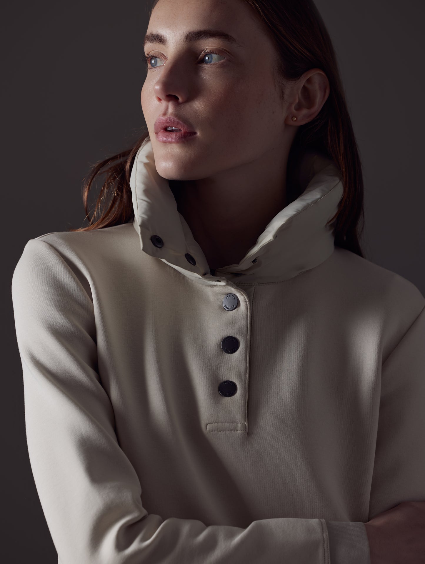Closeup detailed view of buttons and collar on women's Align Pullover in Bone white from AETHER Apparel.
