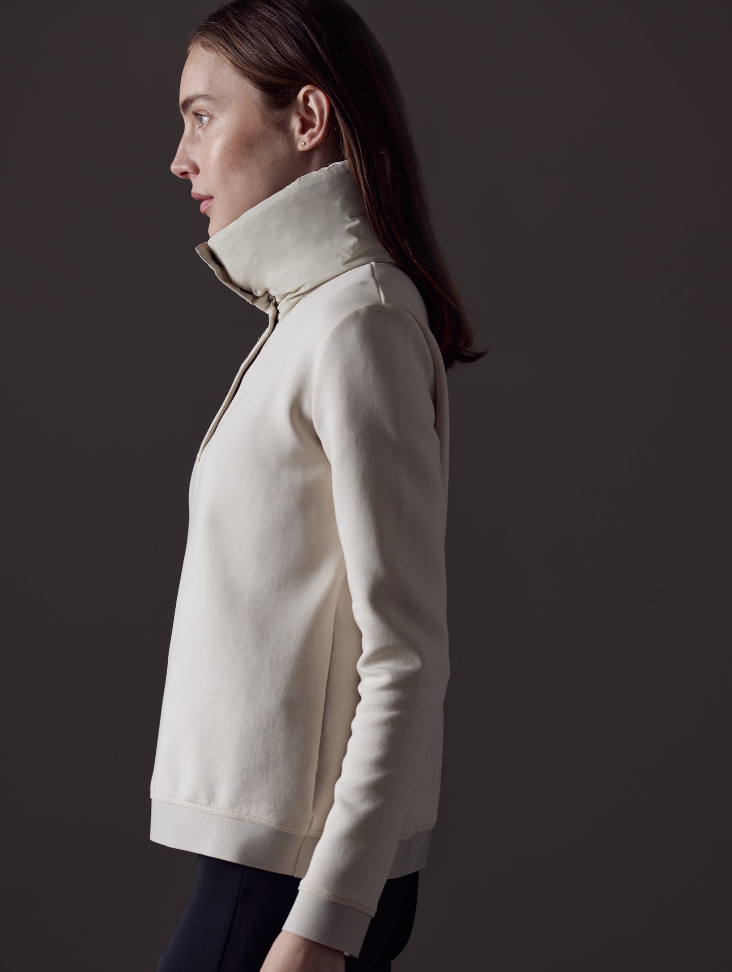 Side profile view of woman wearing Align Pullover in Bone white from AETHER Apparel.