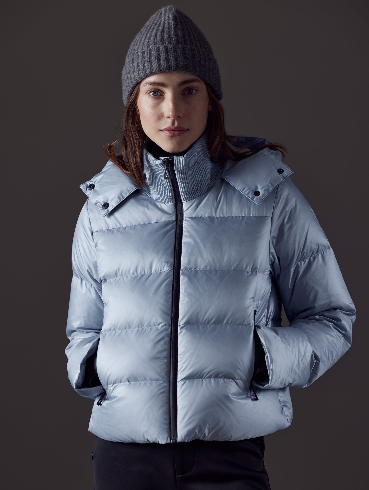 Front body view of woman wearing Aura Puffer Jacket in Flight Blue from AETHER Apparel.